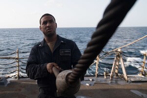 U.S. Navy Boatswain’s Mate 3rd Class Nelson Jiminian-Ovando, from New York, handles a cable extension on the boat deck aboard the guided-missile destroyer USS Chung-Hoon (DDG 93) in the Gulf of Aden, Jan. 25, 2019. The Chung-Hoon is deployed to the U.S. 5th Fleet area of operations in support of naval operations to ensure maritime stability and security in the Central Region, connecting the Mediterranean and the Pacific through the western Indian Ocean and three strategic choke points. (U.S. Navy photo by Mass Communication Specialist 2nd Class Logan C. Kellums)