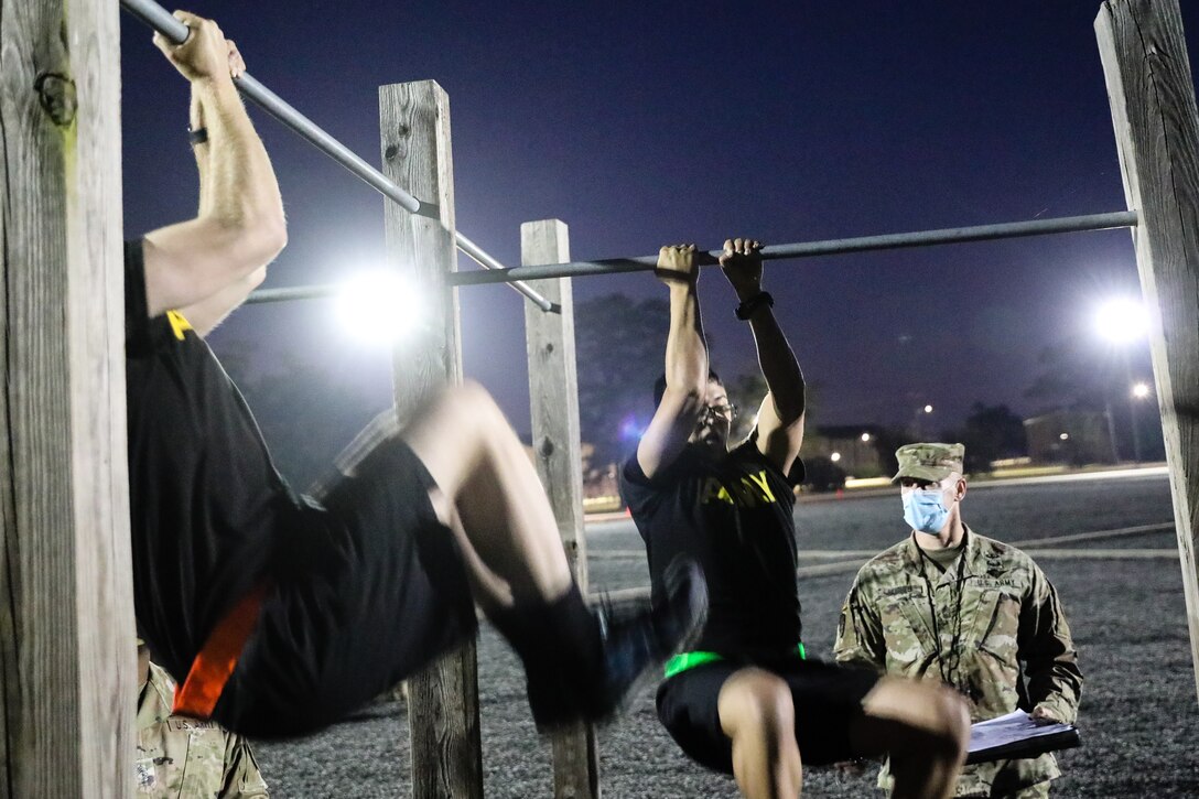 U.S. Army Reserve Spc. Daniel Bush, left, a civil affairs specialist with the 352st Civil Affairs Command, and Staff Sgt. Marco Campos, middle, a civil affairs specialist with the 410th Civil Affairs Battalion, participate in the Army Combat Fitness Test (ACFT) during day one of the 2021 U.S. Army Civil Affairs and Psychological Operations Command (Airborne) Best Warrior Competition at Fort Jackson, S.C., April 8, 2021. The USACAPOC(A) BWC is an annual competition that brings in competitors from across USACAPOC(A) to earn the title of “Best Warrior.” BWC tests the Soldiers’ individual ability to adapt and overcome challenging scenarios and battle-focused events, testing their technical and tactical skills under stress and extreme fatigue.