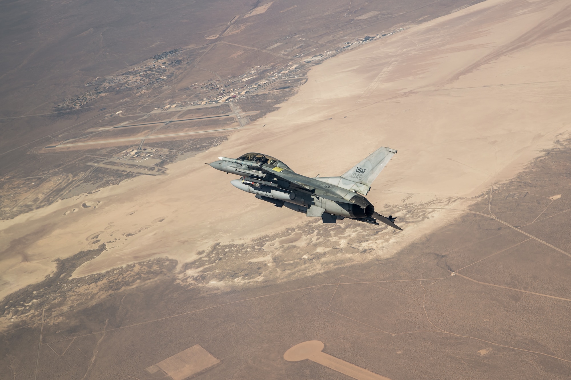 An F-16 assigned to the 416th Flight Test Squadron flies into position over the Precision Impact Range Area on Edwards Air Force Base, California, Feb. 26. The successful drop test was in support of the Korea F-16 Update Program. The ROKAF currently operates 133 KF-16C/D Block 50/52 fighter aircraft, all of which will undergo extensive modernization and upgrades as part of the comprehensive improvement program. Lockheed Martin was awarded a $1.2 billion contract to retrofit the 133 KF-16s and upgrade them to the advanced F-16V configuration, which is the latest technologically and most advanced version of the fourth generation fighter jet. (Air Force photo by Ethan Wagner)