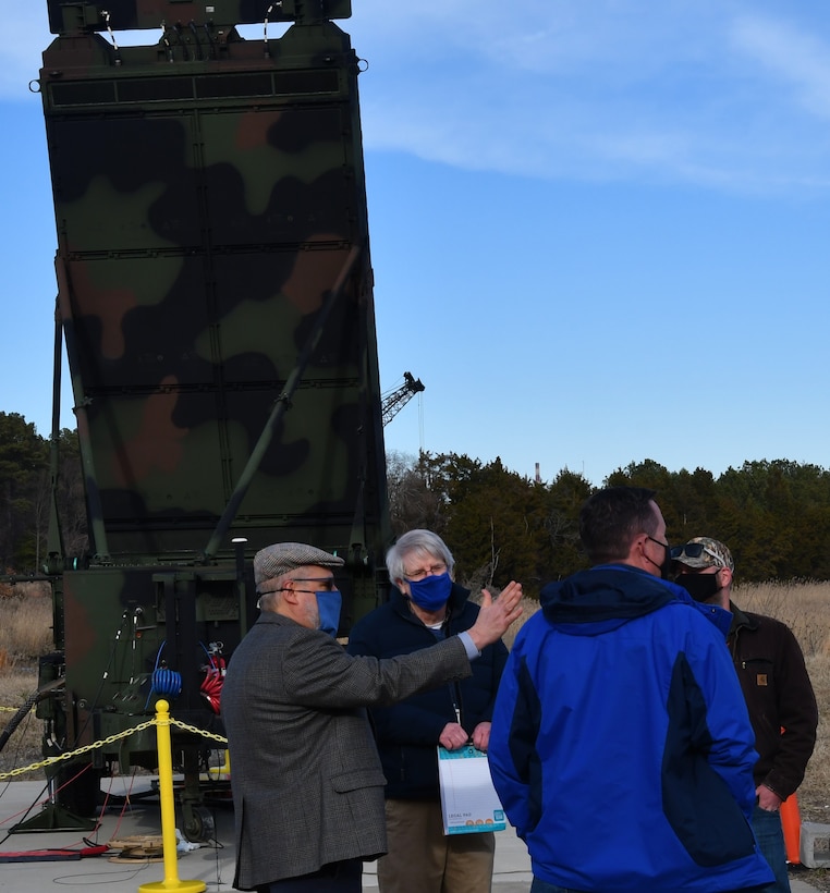 IMAGE:Naval Surface Warfare Center Dahlgren Division (NSWCDD) Principal Engineer Dr. Terry Foreman, G/ATOR Technical Program Manager Bill Shea and Radar Operations Lead Danny Mudd brief NSWCDD Technical Director John Fiore on the AN/TPS-80 Ground/Air Task-Oriented Radar (G/ATOR) system at the Potomac River Test Range. G/ATOR – a mobile unit designed to be stationed anywhere while providing air surveillance and ground weapons locating capabilities – completed five weeks of integrated test evaluations at NSWCDD in support of the U.S. Marine Corps.
