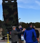 IMAGE:Naval Surface Warfare Center Dahlgren Division (NSWCDD) Principal Engineer Dr. Terry Foreman, G/ATOR Technical Program Manager Bill Shea and Radar Operations Lead Danny Mudd brief NSWCDD Technical Director John Fiore on the AN/TPS-80 Ground/Air Task-Oriented Radar (G/ATOR) system at the Potomac River Test Range. G/ATOR – a mobile unit designed to be stationed anywhere while providing air surveillance and ground weapons locating capabilities – completed five weeks of integrated test evaluations at NSWCDD in support of the U.S. Marine Corps.