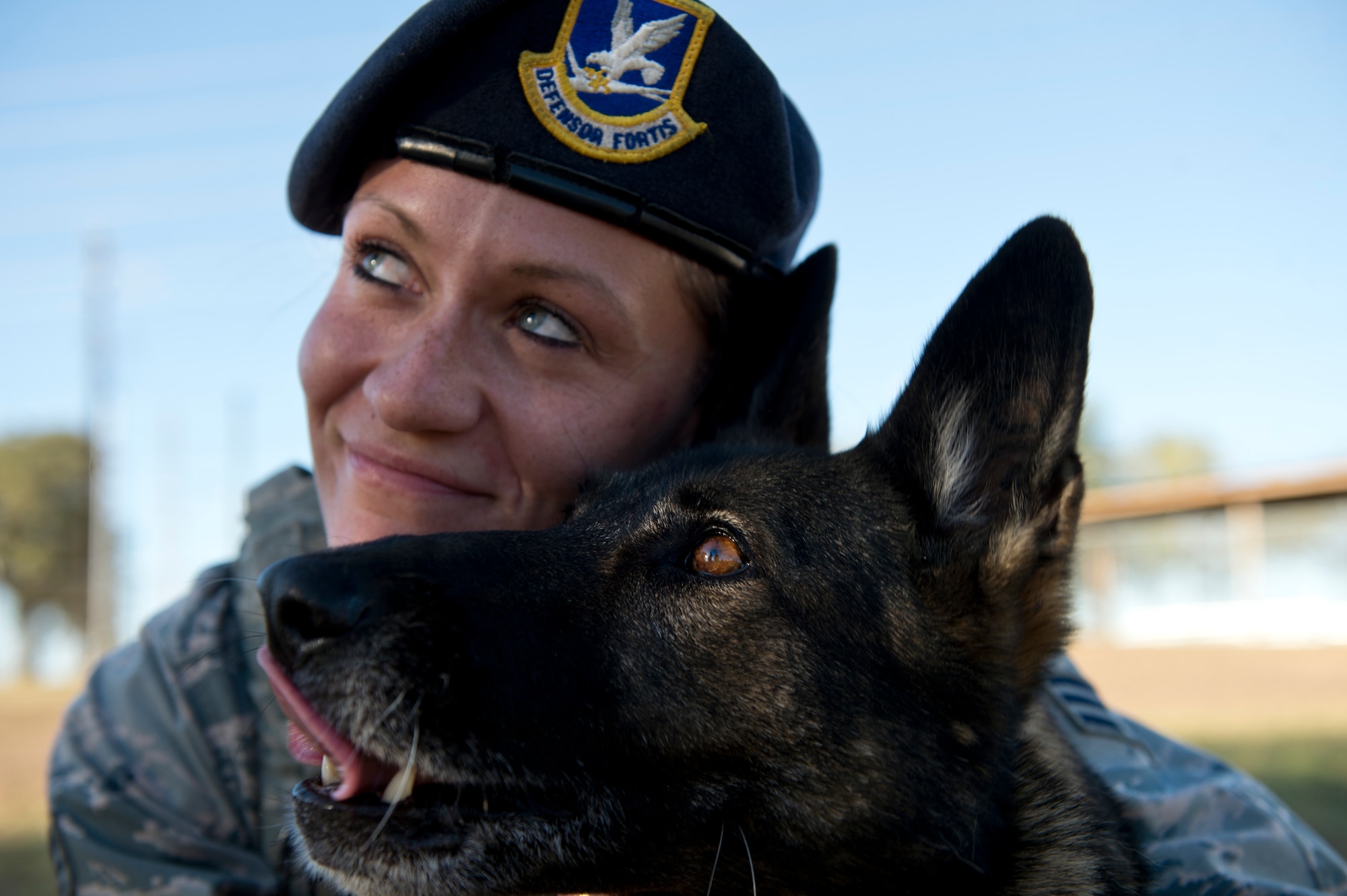 Senior Airman Chelsea LaFever, a military working dog handler from the 802nd Security Forces Squadron, smiles with her dog ZZusa after training at Joint Base San Antonio-Lackland. Upon completion of training tasks, LaFever encourages ZZusa with a treat. LaFever and ZZusa have been training and developing chemistry to complete the day-to-day mission at JBSA-Lackland. (U.S. Air force photo/Staff Sgt. Vernon Young Jr.)