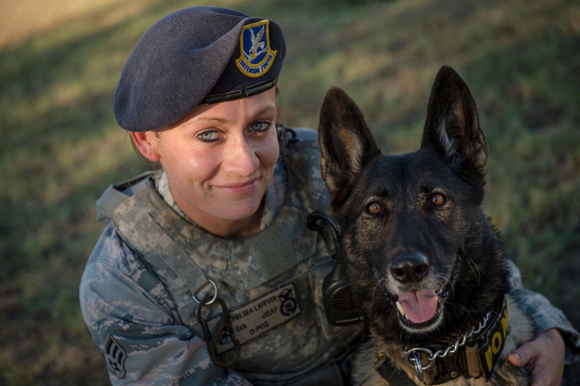 Senior Airman Chelsea LaFever, a military working dog handler from the 802nd Security Forces Squadron, smiles with her dog ZZusa after training at Joint Base San Antonio-Lackland. Upon completion of training tasks, LaFever encourages ZZusa with a treat. LaFever and ZZusa have been training and developing chemistry to complete the day-to-day mission at JBSA-Lackland. (U.S. Air force photo/Staff Sgt. Vernon Young Jr.)