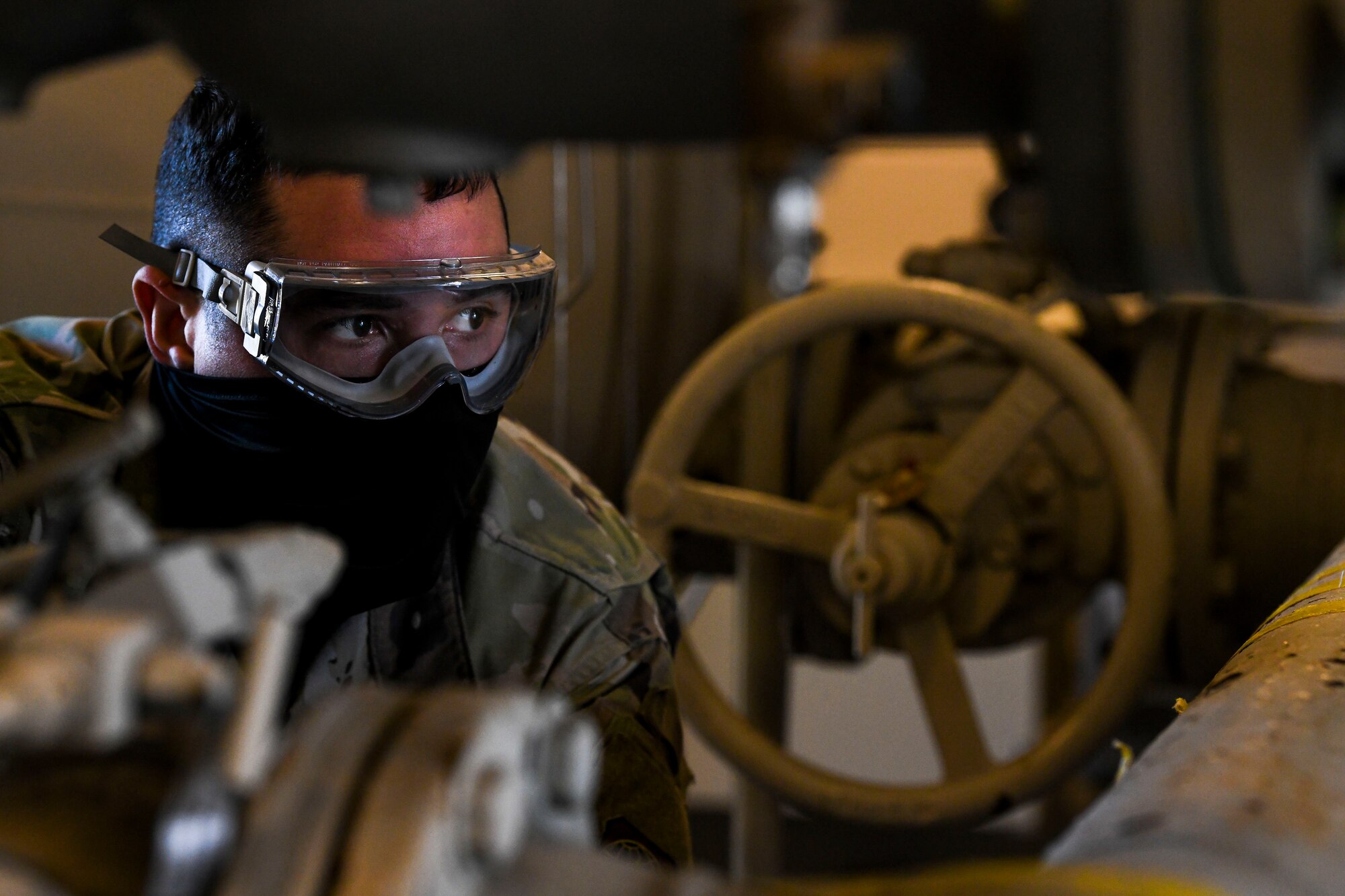 Airman 1st Class Carlos Cruz-Vasquez, 436th Logistics Readiness Squadron fuels laboratory technician, collects a fuel sample for testing at Dover Air Force Base, Delaware, Jan. 12, 2021. Fuel is inspected daily to ensure all aircraft receive the cleanest fuel possible, enabling them to effectively execute Team Dover’s global airlift mission. (U.S. Air Force photo by Airman 1st Class Stephani Barge)