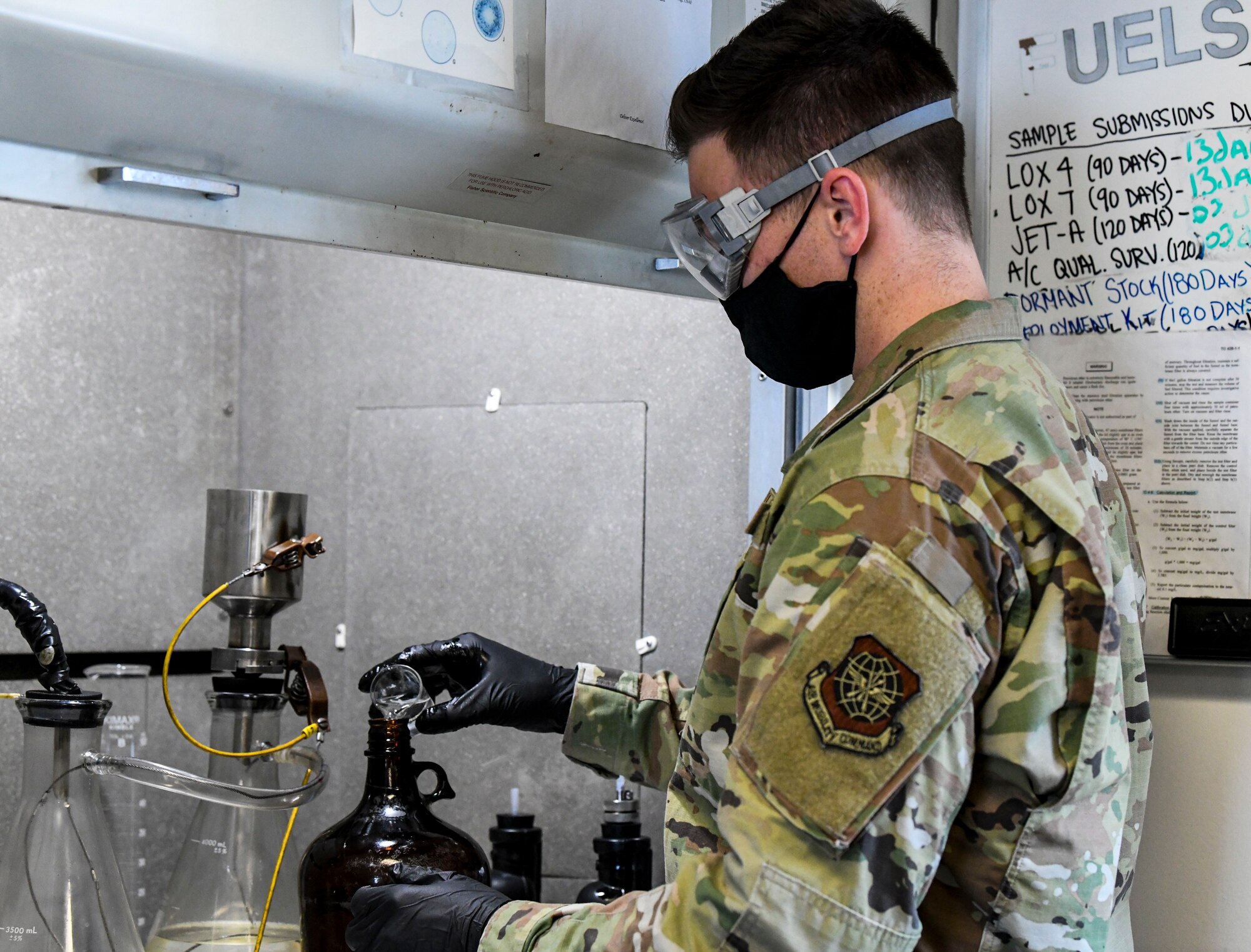 Staff Sgt. Brian Elrod, 436th Logistics Readiness Squadron fuels laboratory noncommissioned officer in charge, performs a bottle-method test at Dover Air Force Base, Delaware, Jan. 12, 2021. The bottle-method test measures levels of water, additives, sediment and particulates in fuel to ensure all aircraft receive the cleanest fuel possible. (U.S. Air Force photo by Airman 1st Class Stephani Barge)