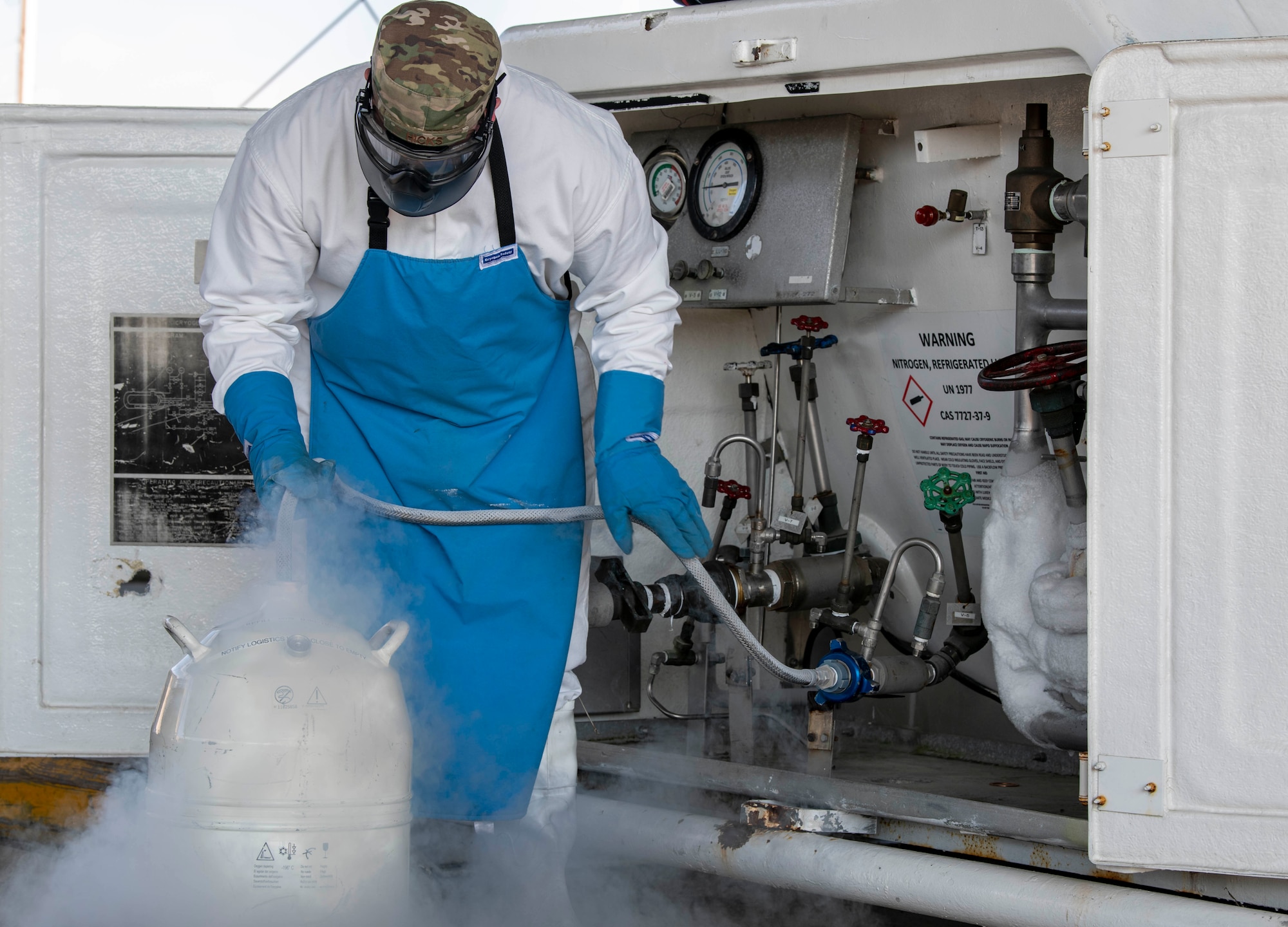 Staff Sgt. Thomas Hicks, 436th Logistics Readiness Squadron fuels cryogenics noncommissioned officer in charge, fills a tank with liquid nitrogen at Dover Air Force Base, Delaware, Jan. 13, 2021. Cryogenics Airmen wear special equipment to protect themselves from liquid nitrogen’s dangerously low temperatures of minus 320 degrees Fahrenheit. (U.S. Air Force photo by Airman 1st Class Stephani Barge)