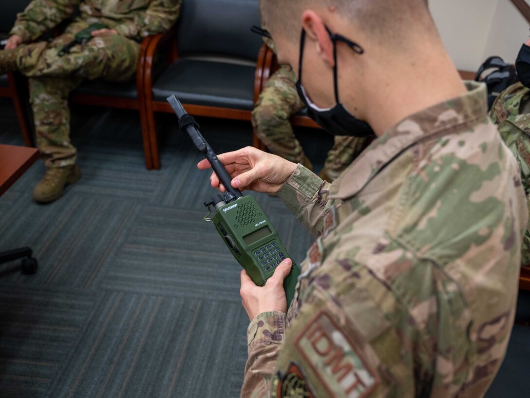 Staff Sgt. Christopher Foster, 436th Operational Medical Readiness Squadron individual duty medical technician, loads frequencies into a wideband networking hand-held radio during exercise Razor Talon at Seymour Johnson Air Force Base, North Carolina, March 22, 2021. Team Dover’s Multi-Capable Airmen program developed and equipped seven Airmen to perform tasks outside of their Air Force Specialty Code. RT was the first time an MCA team from Dover AFB participated in an exercise. (U.S. Air Force photo by Airman 1st Class Faith Schaefer)