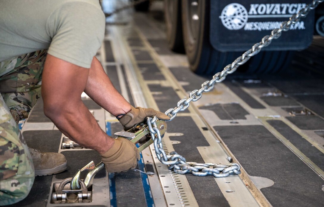 Staff Sgt. Ricky Parrish, 4th Logistic Readiness Squadron aerial transporter, chains a fuel truck to the cargo floor of a Dover Air Force Base C-17 Globemaster III during exercise Razor Talon at Seymour Johnson AFB, North Carolina, March 23, 2021. Mobility Airmen participated in RT to enhance readiness and assist in implementation of the Agile Combat Employment concept across the Air Force. (U.S. Air Force photo by Airman 1st Class Faith Schaefer)