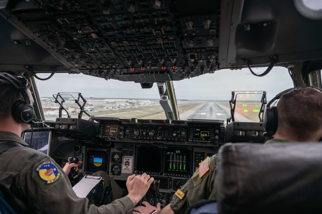 First Lt. Brent Johnson, left, and Capt. James Dimmick, both 3rd Airlift Squadron pilots, prepare to land a Dover Air Force Base C-17 Globemaster III during exercise Razor Talon at Marine Corps Air Station Cherry Point, North Carolina, March 23, 2021. Mobility Airmen participated in RT to enhance readiness and assist in implementation of the Agile Combat Employment concept across the Air Force. (U.S. Air Force photo by Airman 1st Class Faith Schaefer)