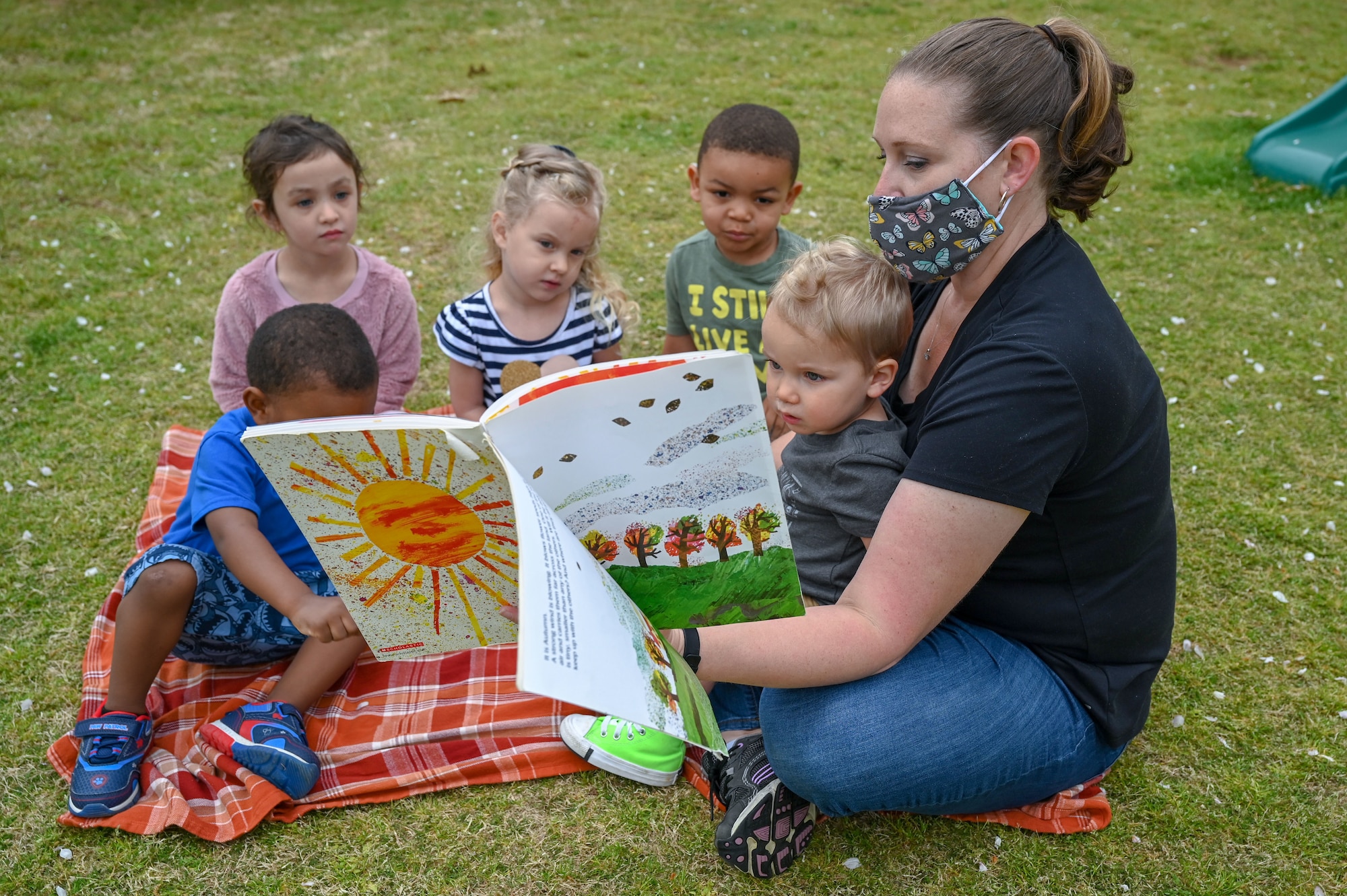 a woman reads to children