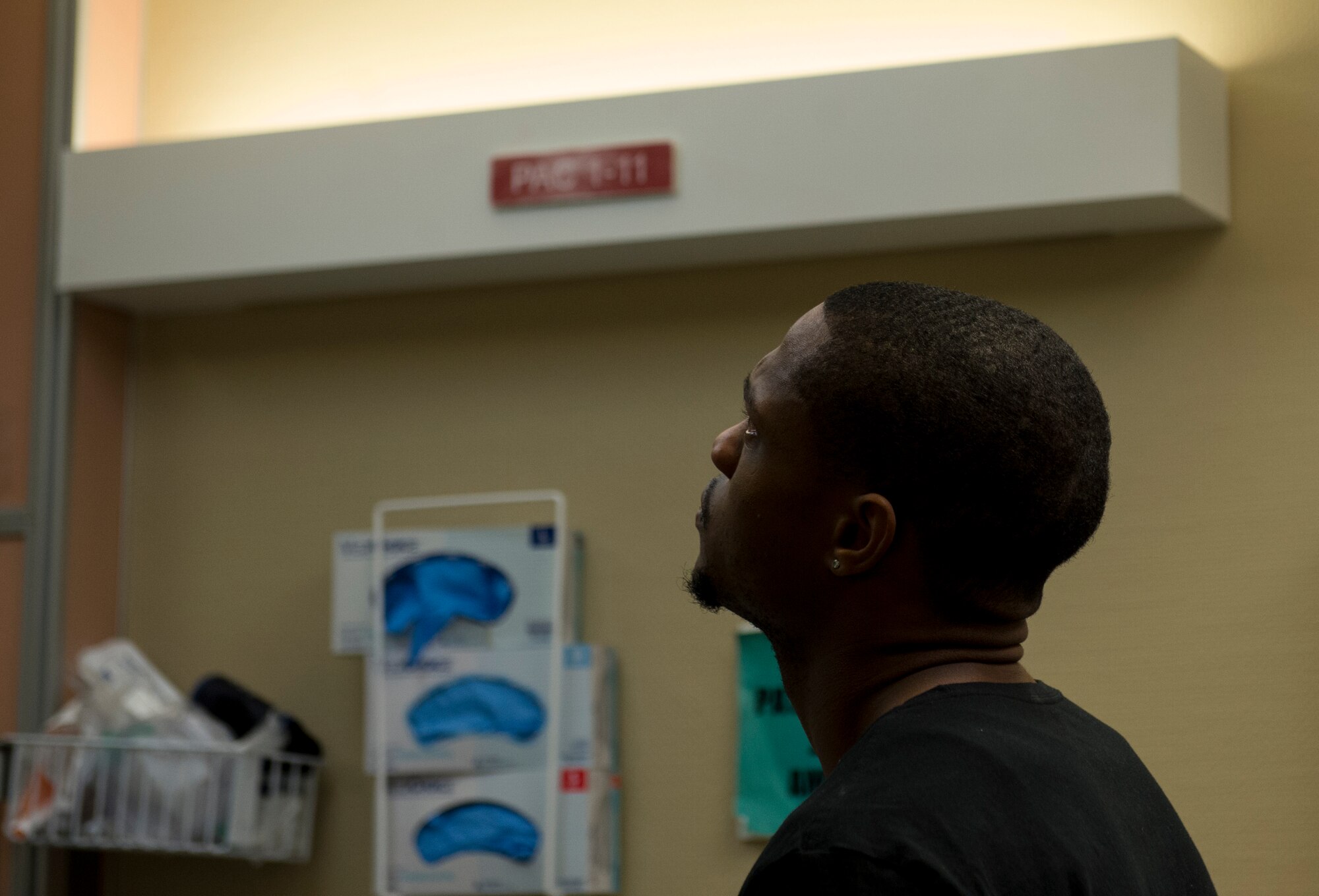 Wendell Thibeaux, husband of Staff Sgt. Chantel Thibeaux, Dental technical school, Joint Base-Fort Sam Houston, Texas, dental assistant instructor, holds back tears as doctors read the surgery risks to his wife prior to double mastectomy surgery. Thibeaux, 27, the youngest breast cancer patient at San Antonio Medical Center, was diagnosed with breast cancer in Feb. 2014 after Wendell encouraged her to get a lump on her breasts checked. (U.S. Air Force photo/Staff Sgt. Vernon Young Jr.)