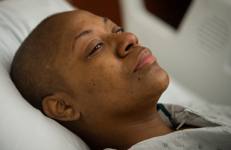 A tear begins to fall down the face of Staff Sgt. Chantel Thibeaux, Joint Base-Fort Sam Houston, Texas, dental assistant instructor, as she receives treatment from a nurse after surgery at the San Antonio Medical Center. With her husband and mother standing by her bed side saying encouraging words, Thibeaux slowly regains energy throughout the night. (U.S. Air Force photo/Staff Sgt. Vernon Young Jr.)