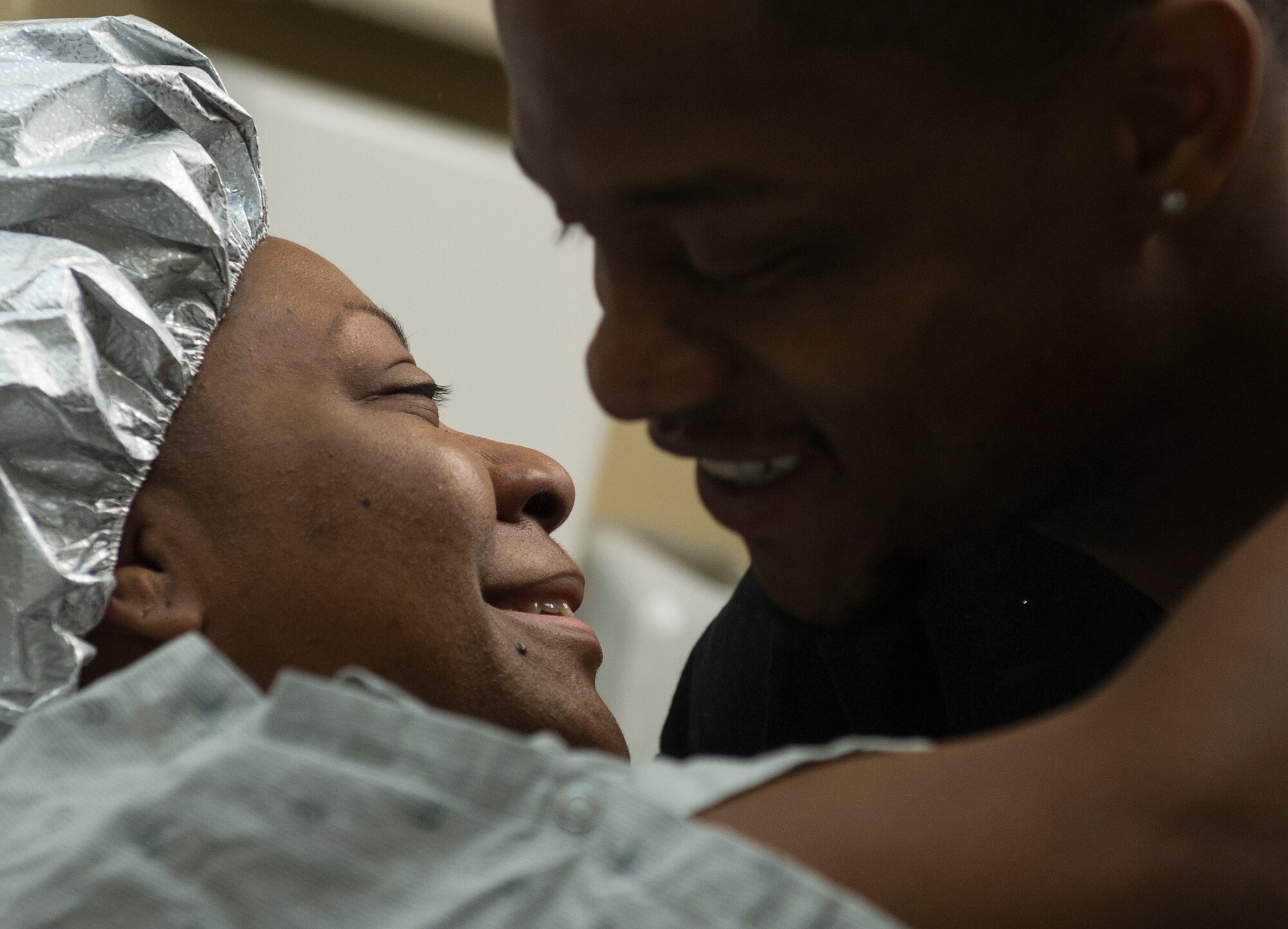 Wendell Thibeaux, husband of Staff Sgt. Chantel Thibeaux, Dental technical school, Joint Base-Fort Sam Houston, Texas, dental assistant instructor, hug prior to Chantel's double mastectomy surgery. Thibeaux, 27, the youngest breast cancer patient at San Antonio Medical Center, was diagnosed with breast cancer in Feb. 2014 after Wendell encouraged her to get a lump on her breast checked. (U.S. Air Force photo/Staff Sgt. Vernon Young Jr.)