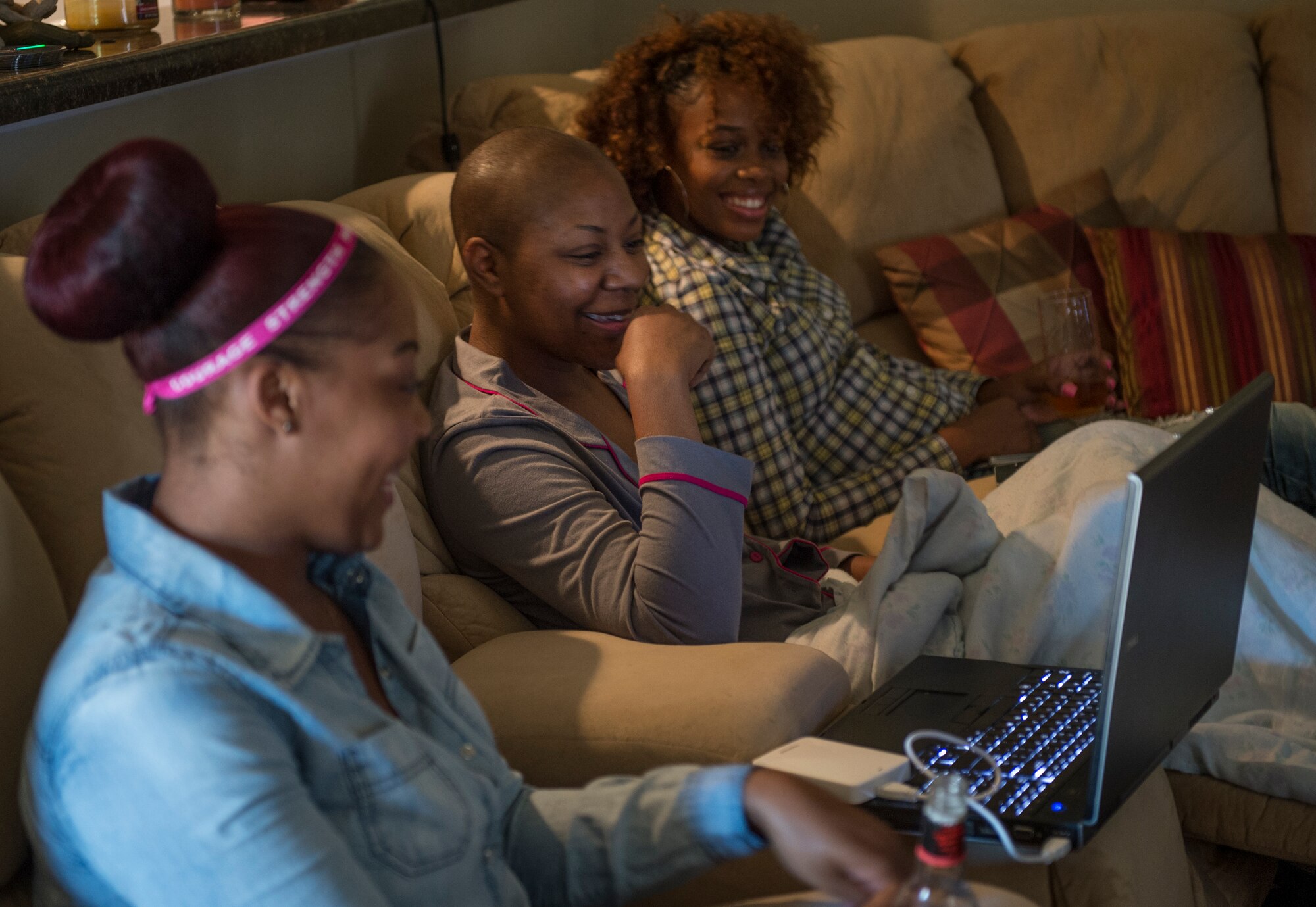 Staff Sgt. Chantel Thibeaux, Joint Base-Fort Sam Houston, Texas, dental assistant instructor, spends time with her friends after having double mastectomy surgery. About 15 family and friends gathered at her house to celebrate a successful surgery and provide love to Thibeaux during her quest to defeat cancer. (U.S. Air Force photo/Staff Sgt. Vernon Young Jr.)