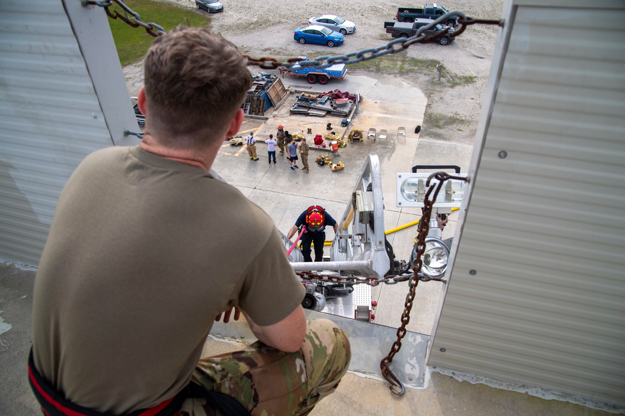 6th Civil Engineer Squadron (CES) Fire and Emergency Services Airmen practice ladder climbing up a structure during a live-burn exercise at MacDill Air Force Base, Fla, March 23, 2021.