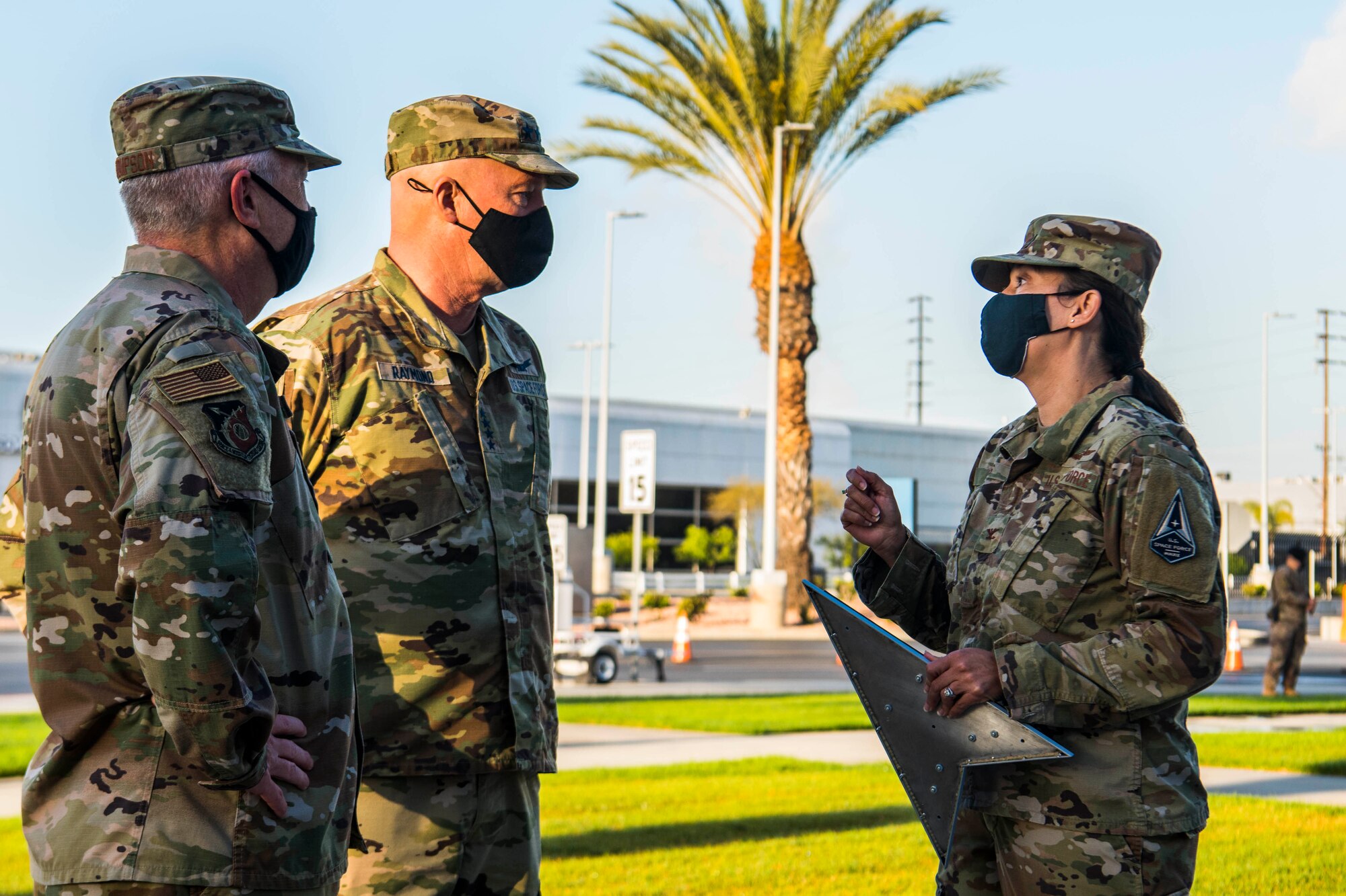 U.S. Air Force Lt. Gen. John F. Thompson, Space and Missile Systems Center commander and Program Executive Officer for Space, left, U.S. Space Force Gen. John W. “Jay” Raymond, Chief of Space Operations, middle, and Col. Becky M. Beers, 61st Air Base Group commander, engage with one another during Raymond’s visit to Los Angeles Air Force Base, California, April 7, 2021. Raymond, along with Chief Master Sergeant of the Space Force Roger A. Towberman, traveled to LAAFB to lead and participate in a number of planned events that included a Senior Leader Summit, Civic Leader Engagement, virtual all call and the announcement of the planned organizational structure for Space Systems Command which is scheduled to activate this summer. (U.S. Space Force photo by Staff Sgt. Luke Kitterman)