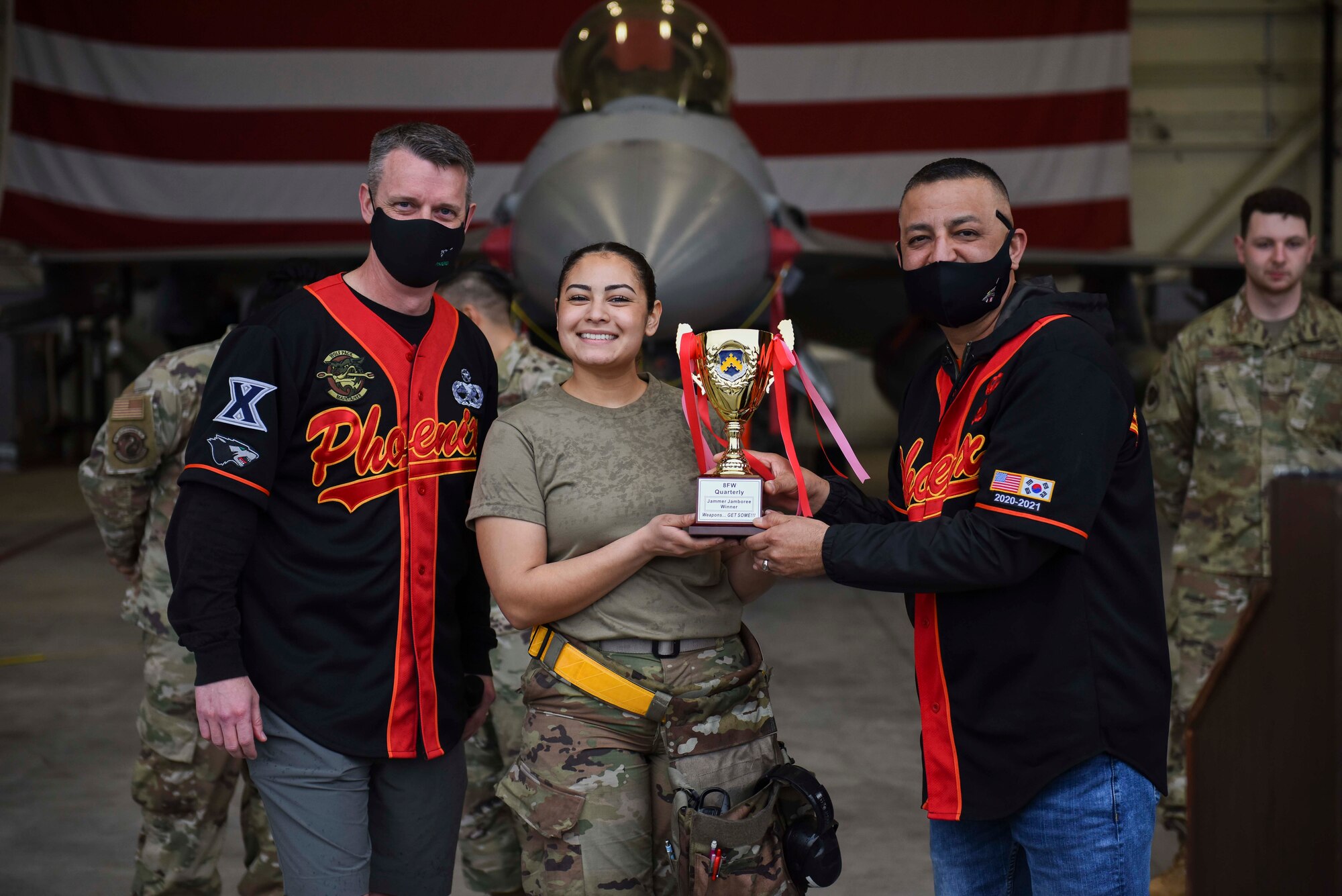 Airmen pose with a trophy