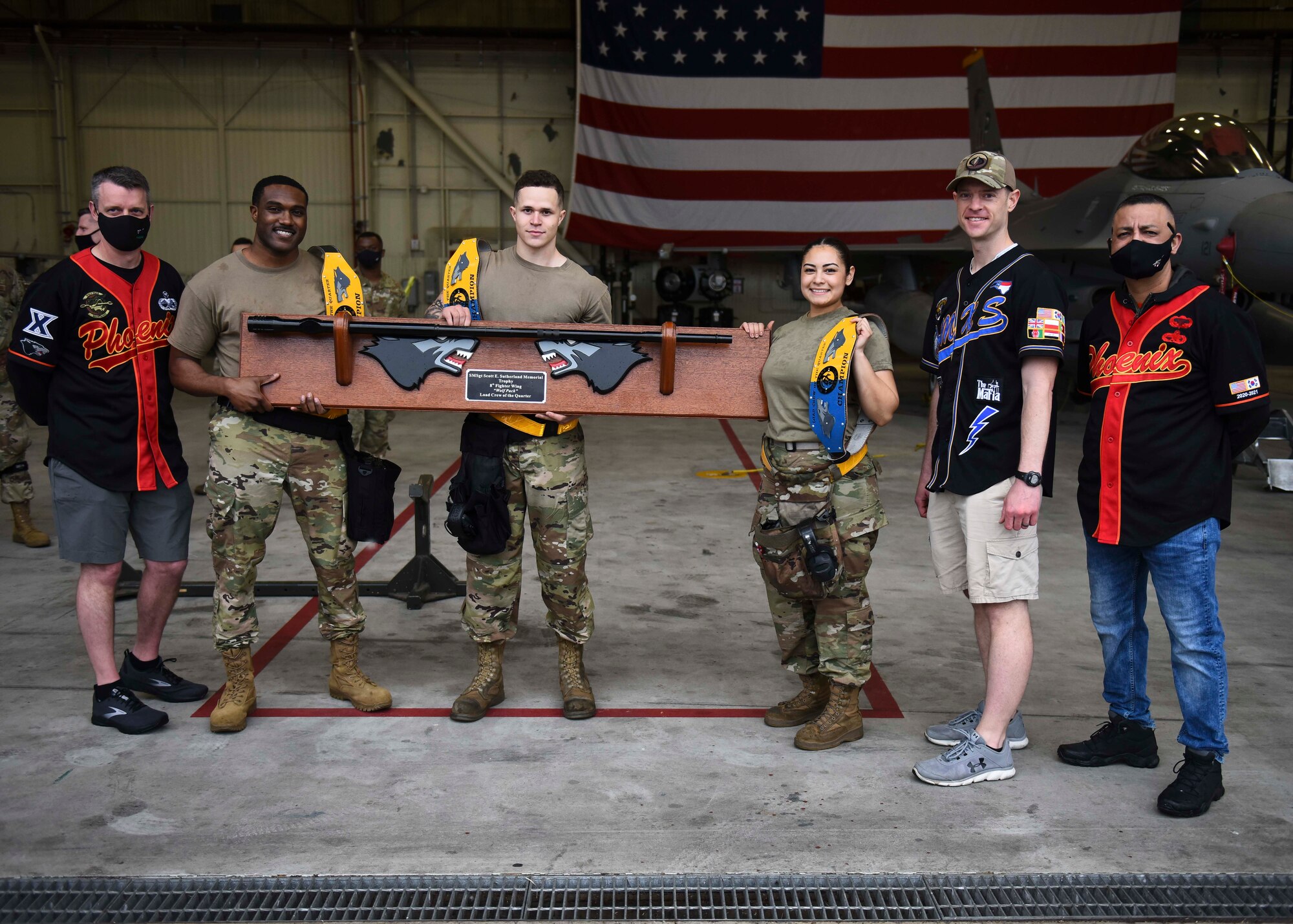 Airmen pose with a trophy