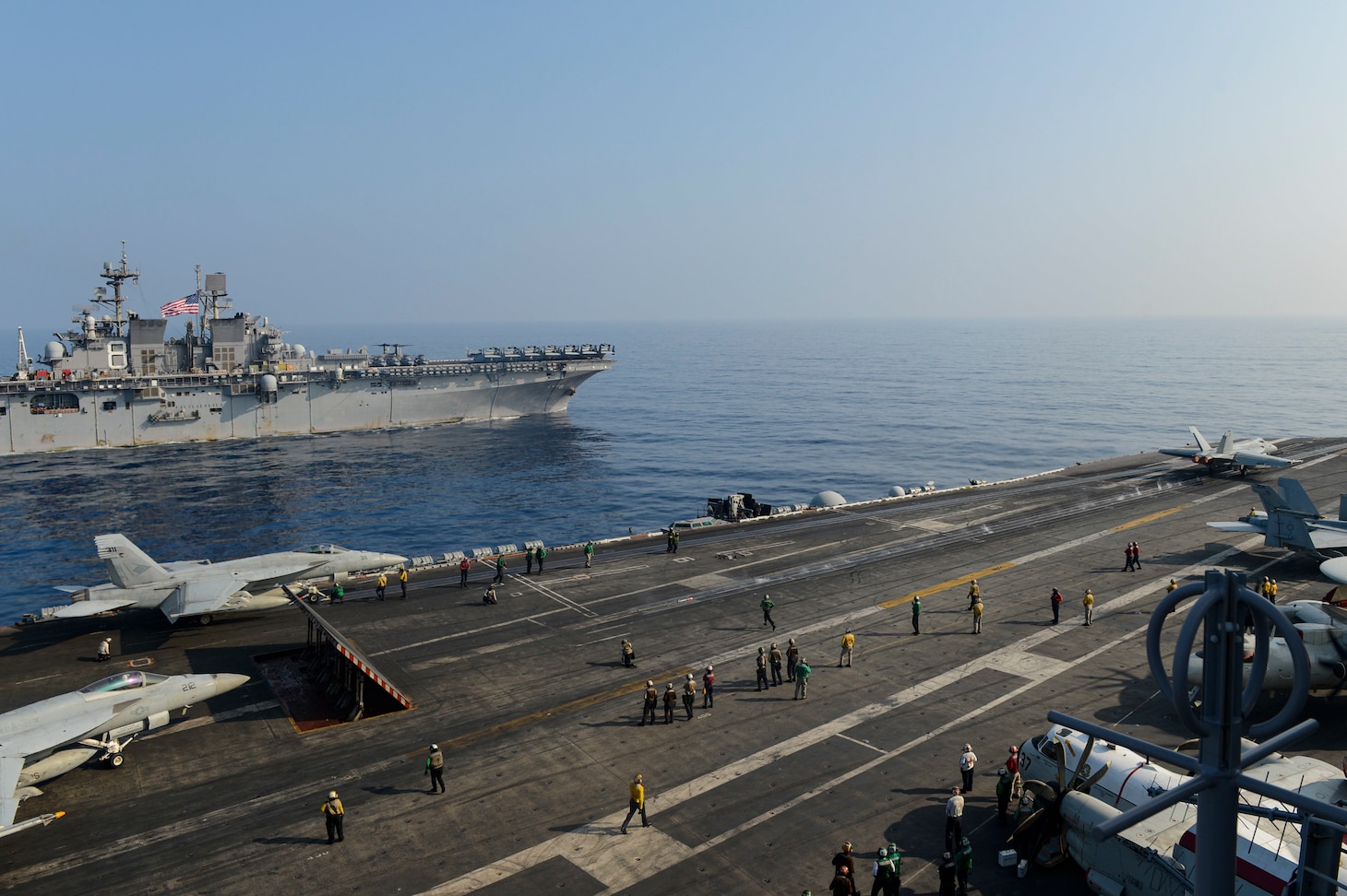 SOUTH CHINA SEA (April 9, 2021) – The Theodore Roosevelt Carrier Strike Group transits in formation with the Makin Island Amphibious Ready Group in the South China Sea April 9, 2021. The Theodore Roosevelt Carrier Strike Group, Makin Island Amphibious Ready Group and the Ticonderoga-class guided-missile cruiser USS Port Royal (CG 73) are conducting expeditionary strike force operations during their deployments to the 7th Fleet area of operations. As the U.S. Navy's largest forward-deployed fleet, 7th Fleet routinely operates and interacts with 35 maritime nations while conducting missions to preserve and protect a free and open Indo-Pacific region. (U.S. Navy photo by Mass Communication Specialist Seaman Faith McCollum)