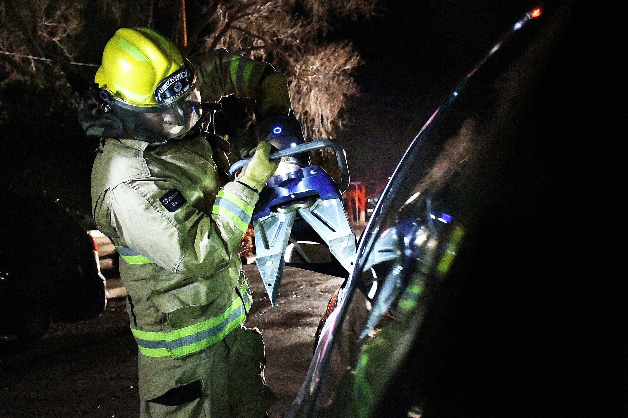 Firefighters from the 152nd Civil Engineer Squadron use the jaws of life to open a car door during Operation Chemical Blackjack Mar. 7, 2021, at the Nevada Air National Guard base in Reno. The three-day exercise was designed to ensure Airmen are ready for chemical, biological, radiological or nuclear (CBRN) threats is presented.