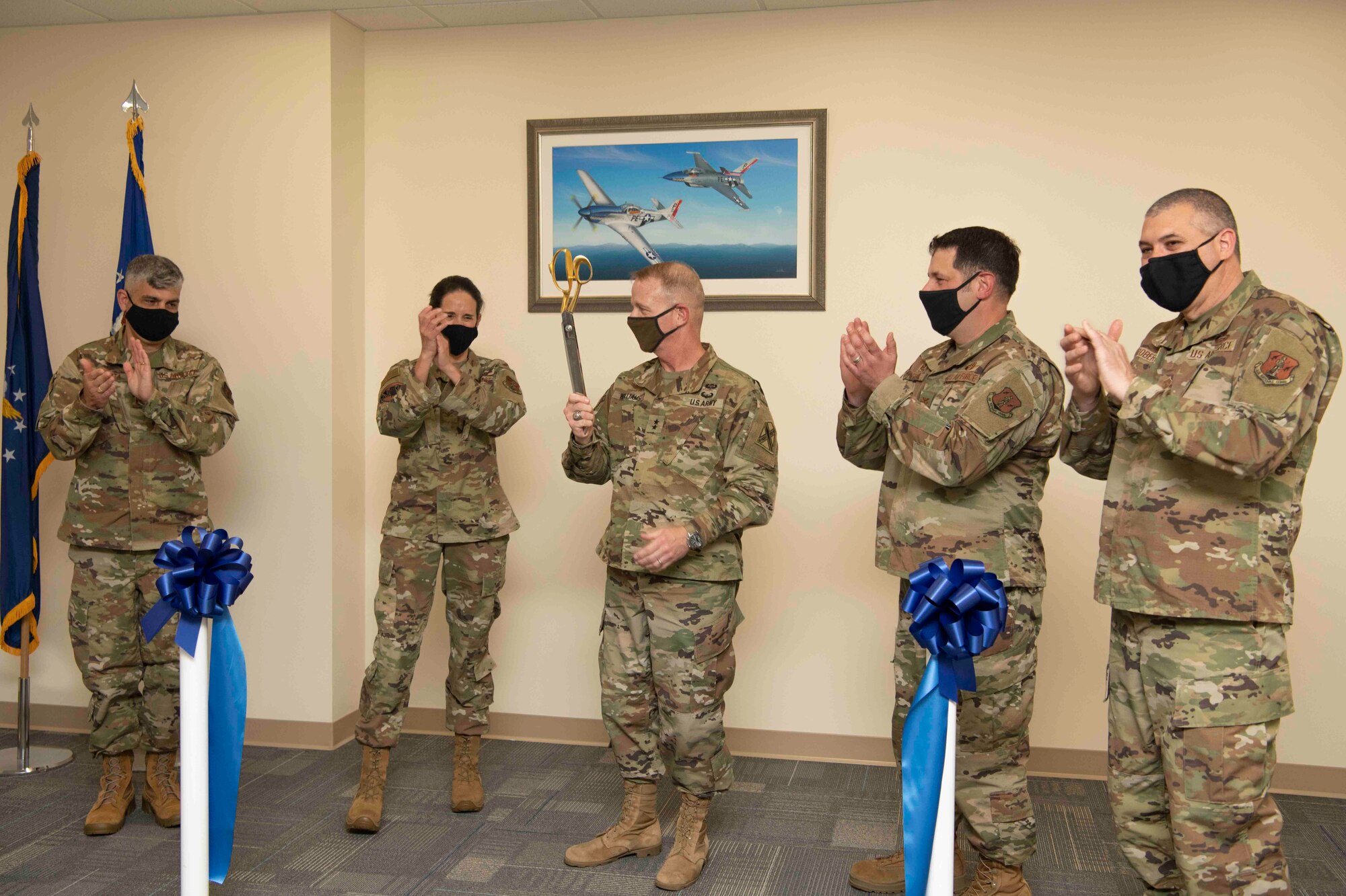 U.S. Air Force leaders applaud during a ribbon cutting ceremony
