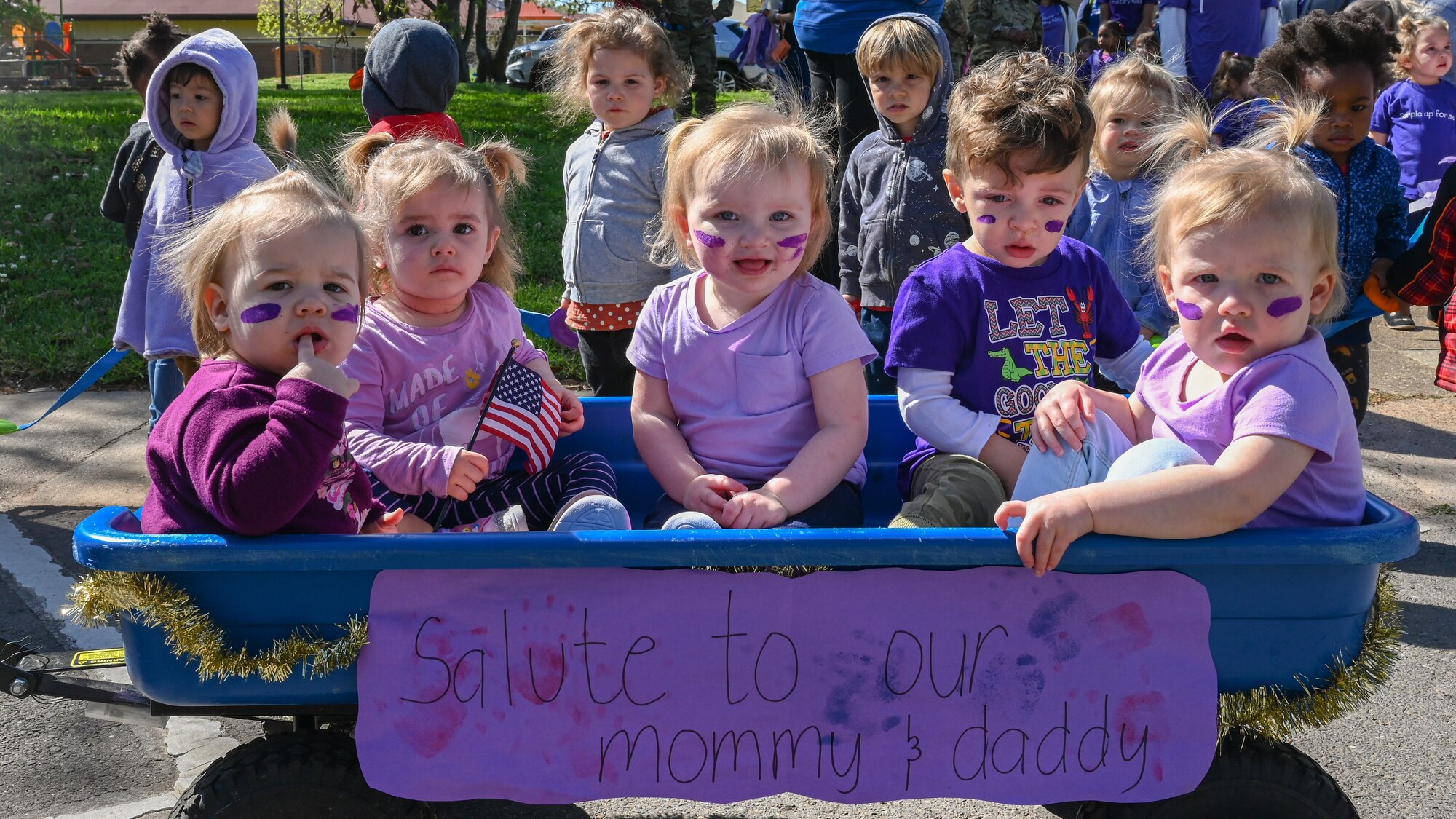 Military children pose for a photo during the Military Child Parade at Barksdale Air Force Base, Louisiana, April 1, 2021.