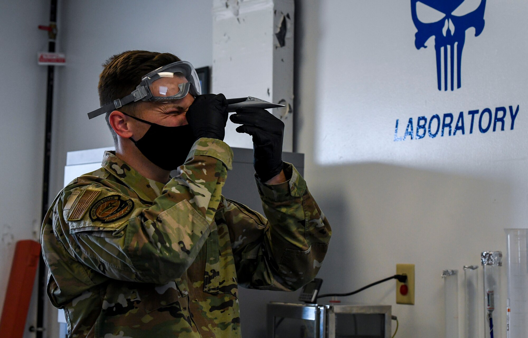 Staff Sgt. Brian Elrod, 436th Logistics Readiness Squadron fuels laboratory noncommissioned officer in charge, looks through a refractometer to inspect the water content from a fuel sample at Dover Air Force Base, Delaware, Jan. 12, 2021. The refractometer measures the effectiveness of additives by separating water in the fuel. (U.S. Air Force photo by Airman 1st Class Stephani Barge)