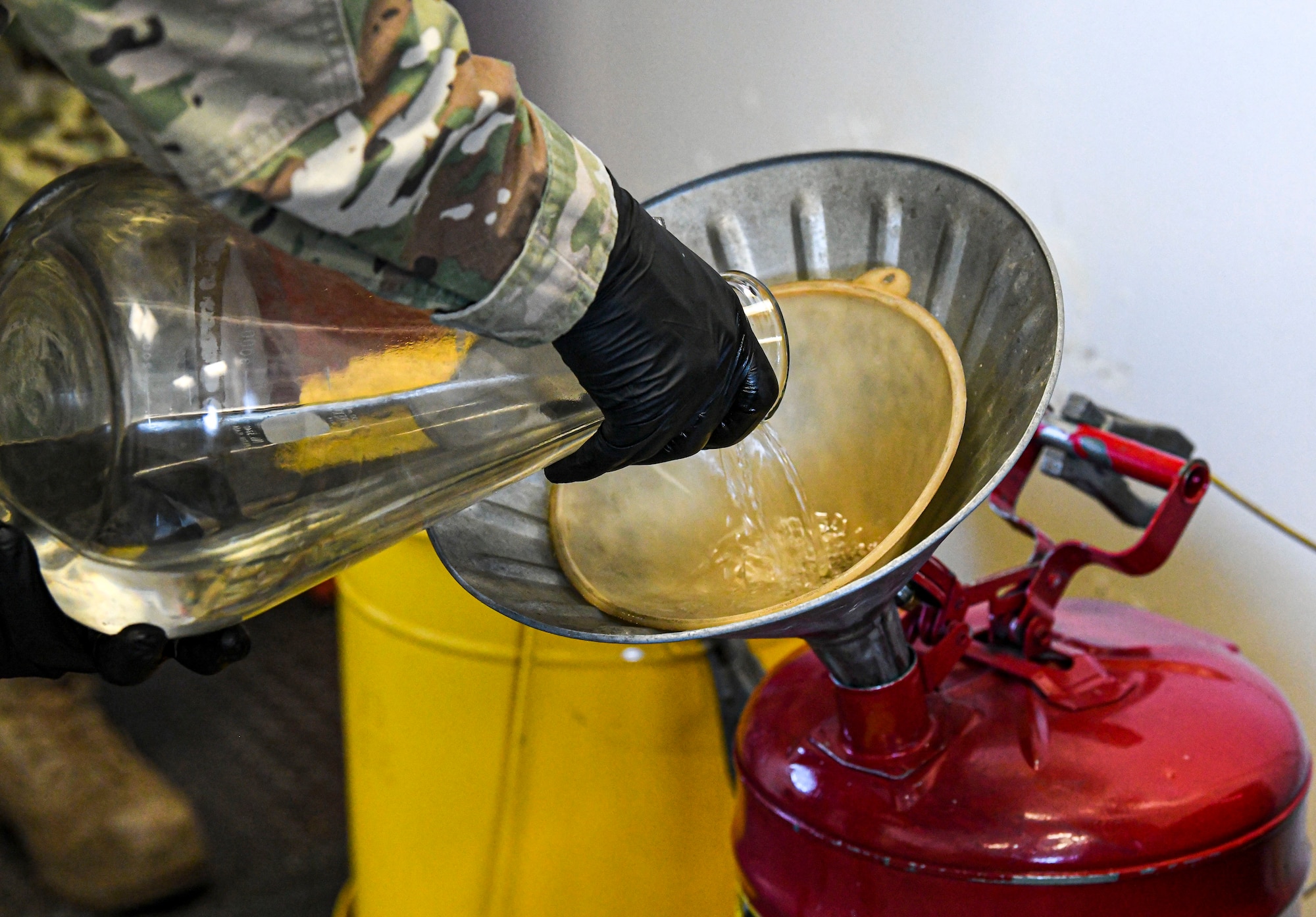 Staff Sgt. Brian Elrod, 436th Logistics Readiness Squadron fuels laboratory noncommissioned officer in charge, stores a recently tested fuel sample in a container for later redistribution at Dover Air Force Base, Delaware, Jan. 12, 2021. Fuel is inspected daily to ensure all aircraft receive the cleanest fuel possible. (U.S. Air Force photo by Airman 1st Class Stephani Barge)