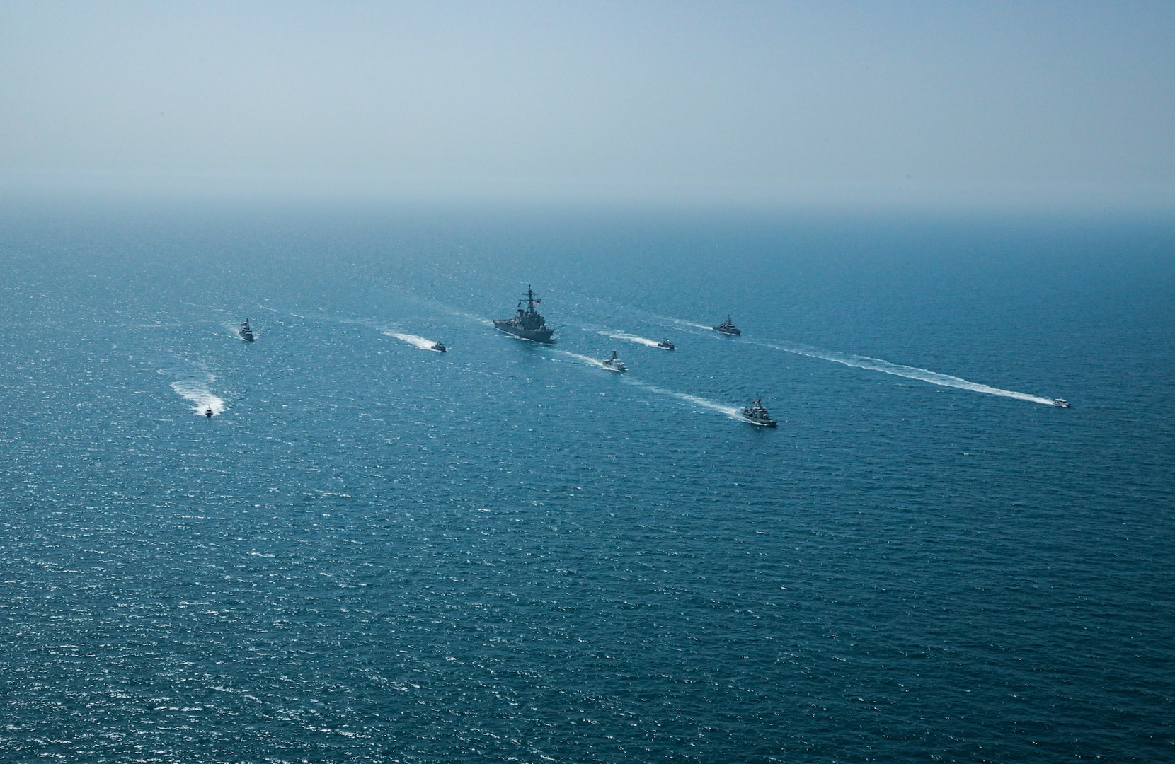 Royal Bahrain Naval Force fast attack craft RBNS Abdul Rahman Al-fadel (P 22), Bahrain Coast Guard response boats Hawar 5 and Hawar 4, U.S. Navy guided-missile destroyer USS Mahan (DDG 72), patrol coastal ships USS Squall (PC 7) and USS Hurricane (PC 3), U.S. Coast Guard patrol boat USCGC Adak (WBP 1333) and two Mark VI patrol boats operate in formation during exercise Neon Defender in the Arabian Gulf, April 7. Neon Defender 21 is a bilateral maritime exercise between the U.S. and Bahrain, designed to enhance interoperability and readiness, fortify military-to-military relationships and advance operational capabilities, allowing participating naval forces to effectively develop the necessary skills to address threats to regional security, freedom of navigation and the free flow of commerce. (Army Photo by Spc. Evens Milcette Jr.)