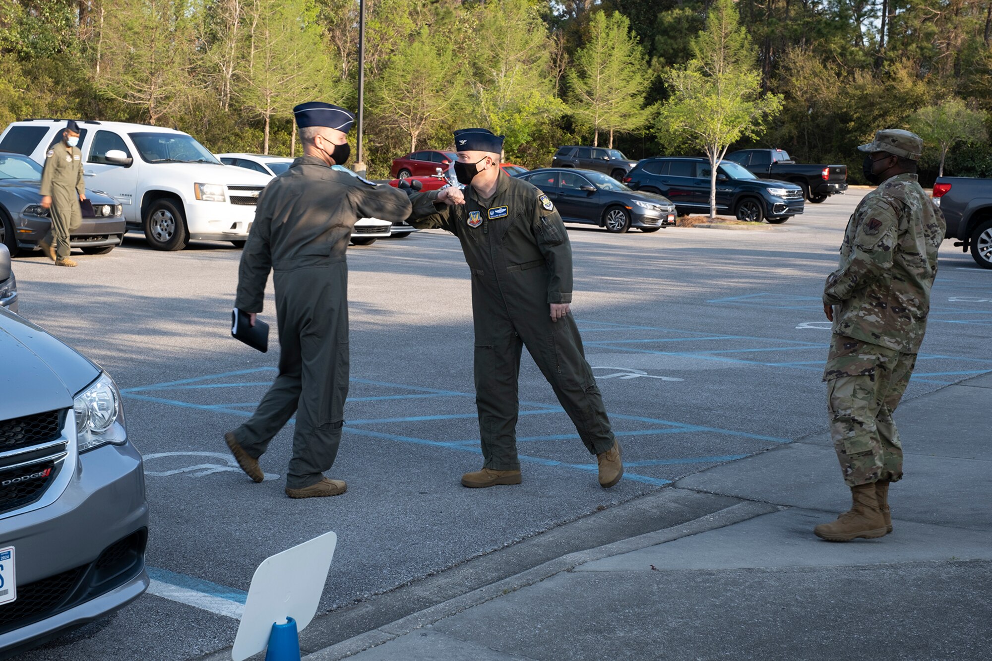 photo of two Airmen greeting the other