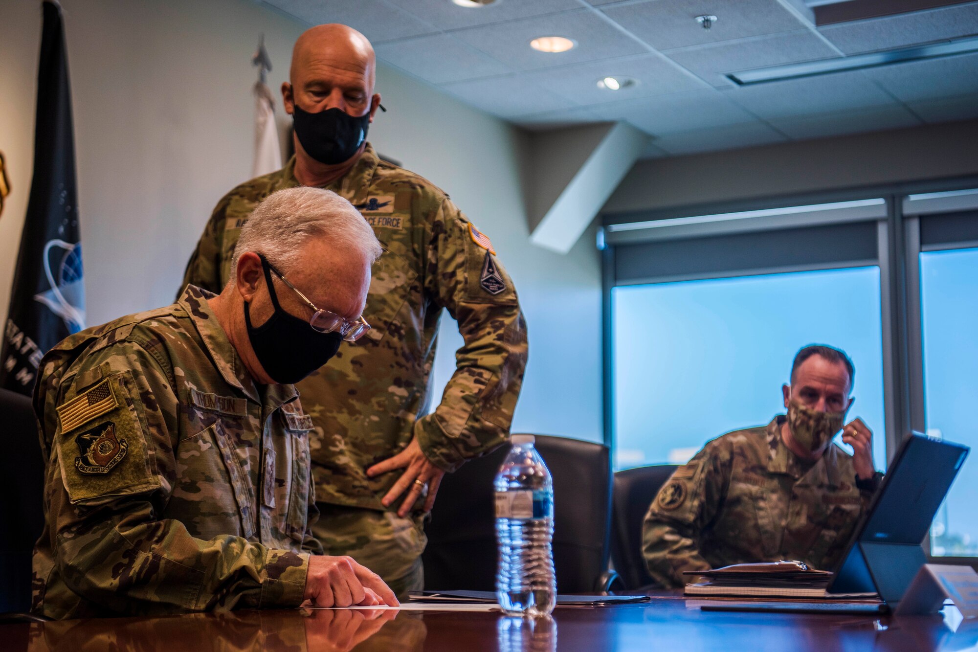 U.S. Air Force Lt. Gen. John F. Thompson, Space and Missile Systems Center commander and Program Executive Officer for Space, left, U.S. Space Force Gen. John W. “Jay” Raymond, Chief of Space Operations, middle, and U.S. Air Force Brig. Gen. Patrick S. Ryder, Director of Public Affairs, Office of the Secretary of the Air Force, prepare before a virtual media roundtable at Los Angeles Air Force Base, California, April 8, 2021. The engagement focused on answering questions about the newly released organizational structure for the Space Systems Command. (U.S. Space Force photo by Staff Sgt. Luke Kitterman)