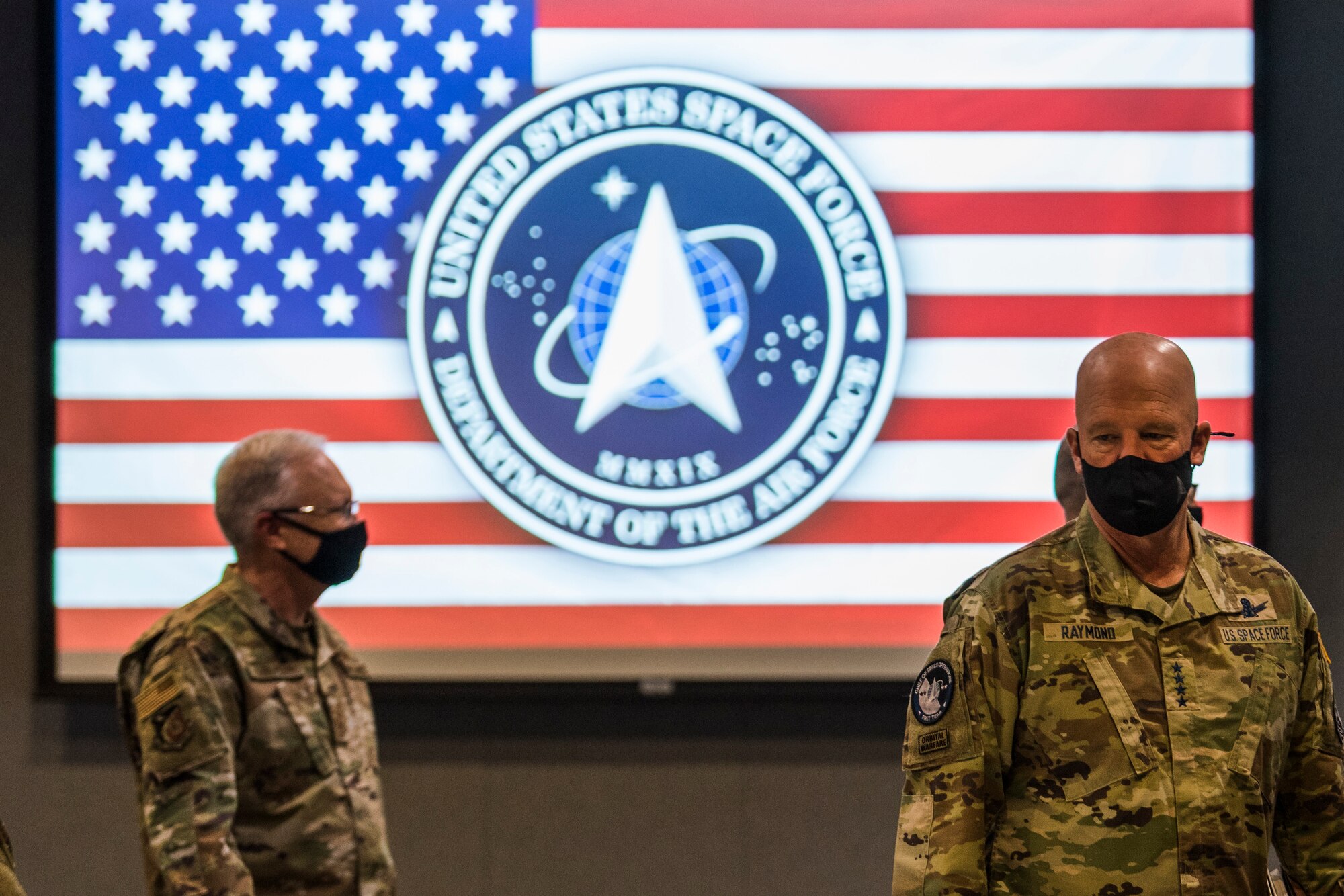 U.S. Space Force Gen. John W. “Jay” Raymond, Chief of Space Operations, right, and U.S. Air Force Lt. Gen. John F. Thompson, Space and Missile Systems Center commander and Program Executive Officer for Space, walk into the Gordon Conference Center prior to a Senior Leader Summit at Los Angeles Air Force Base, California, April 7, 2021. Now in its second year since establishment, the U.S. Space Force and its leaders are focusing on integrating the service across the DoD, interagency, commercial industry, and allies and partners, as well as speeding up acquisitions to outpace competitors. (U.S. Space Force photo by Staff Sgt. Luke Kitterman)