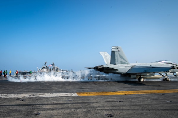 SOUTH CHINA SEA (April 9, 2021) – An F/A-18F Super Hornet, assigned to the “Black Knights” of Strike Fighter Squadron (VFA) 154, launches from the flight deck of the aircraft carrier USS Theodore Roosevelt (CVN 71) in the South China Sea April 9, 2021. The Theodore Roosevelt Carrier Strike Group, Makin Island Amphibious Ready Group and the Ticonderoga-class guided-missile cruiser USS Port Royal (CG 73) are conducting expeditionary strike force operations during their deployments to the 7th Fleet area of operations. As the U.S. Navy's largest forward-deployed fleet, 7th Fleet routinely operates and interacts with 35 maritime nations while conducting missions to preserve and protect a free and open Indo-Pacific region. (U.S. Navy photo by Mass Communication Specialist 3rd Class Dartañon D. De La Garza)