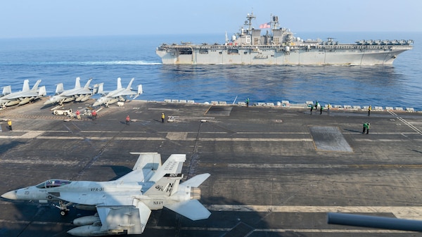 SOUTH CHINA SEA (April 9, 2021) – The Theodore Roosevelt Carrier Strike Group transits in formation with the Makin Island Amphibious Ready Group in the South China Sea April 9, 2021. The Theodore Roosevelt Carrier Strike Group, Makin Island Amphibious Ready Group and the Ticonderoga-class guided-missile cruiser USS Port Royal (CG 73) are conducting expeditionary strike force operations during their deployments to the 7th Fleet area of operations. As the U.S. Navy's largest forward-deployed fleet, 7th Fleet routinely operates and interacts with 35 maritime nations while conducting missions to preserve and protect a free and open Indo-Pacific region. (U.S. Navy photo by Mass Communication Specialist Seaman Faith McCollum)