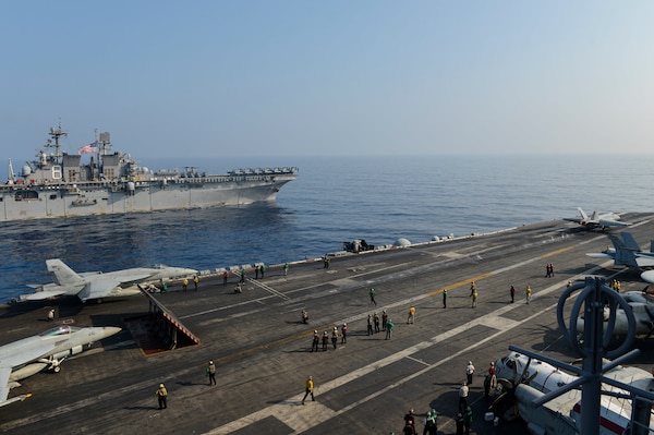 The Theodore Roosevelt Carrier Strike Group transits in formation with the Makin Island Amphibious Ready Group in the South China Sea.