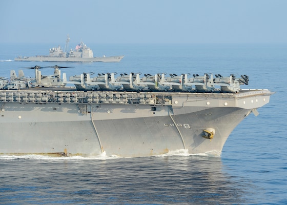 SOUTH CHINA SEA (April 9, 2021) – The Wasp-class amphibious assault ship USS Makin Island (LHD 8), front, and the Ticonderoga-class guided-missile cruiser USS Bunker Hill (CG 52), part of the Theodore Roosevelt Carrier Strike Group, transit the South China Sea April 9, 2021. The Theodore Roosevelt Carrier Strike Group, Makin Island Amphibious Ready Group and the Ticonderoga-class guided-missile cruiser USS Port Royal (CG 73) are conducting expeditionary strike force operations during their deployments to the 7th Fleet area of operations. As the U.S. Navy's largest forward-deployed fleet, 7th Fleet routinely operates and interacts with 35 maritime nations while conducting missions to preserve and protect a free and open Indo-Pacific region. (U.S. Navy photo by Mass Communication Specialist Seaman Faith McCollum)