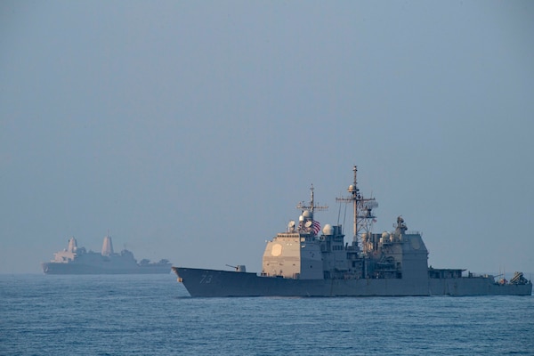 SOUTH CHINA SEA (April 9, 2021) The Ticonderoga-class guided-missile cruiser USS Port Royal (CG 73), right, and the San Antonio-class amphibious transport dock ship USS San Diego (LPD 22) transit in formation with the Theodore Roosevelt Carrier Strike Group and the Makin Island Amphibious Ready Group in the South China Sea April 9, 2021. The Theodore Roosevelt Carrier Strike Group, Makin Island Amphibious Ready Group and Port Royal are conducting expeditionary strike force operations during their deployments to the 7th Fleet area of operations. As the U.S. Navy's largest forward-deployed fleet, 7th Fleet routinely operates and interacts with 35 maritime nations while conducting missions to preserve and protect a free and open Indo-Pacific region. (U.S. Navy photo by Mass Communication Specialist Seaman Eduardo A. Torres)