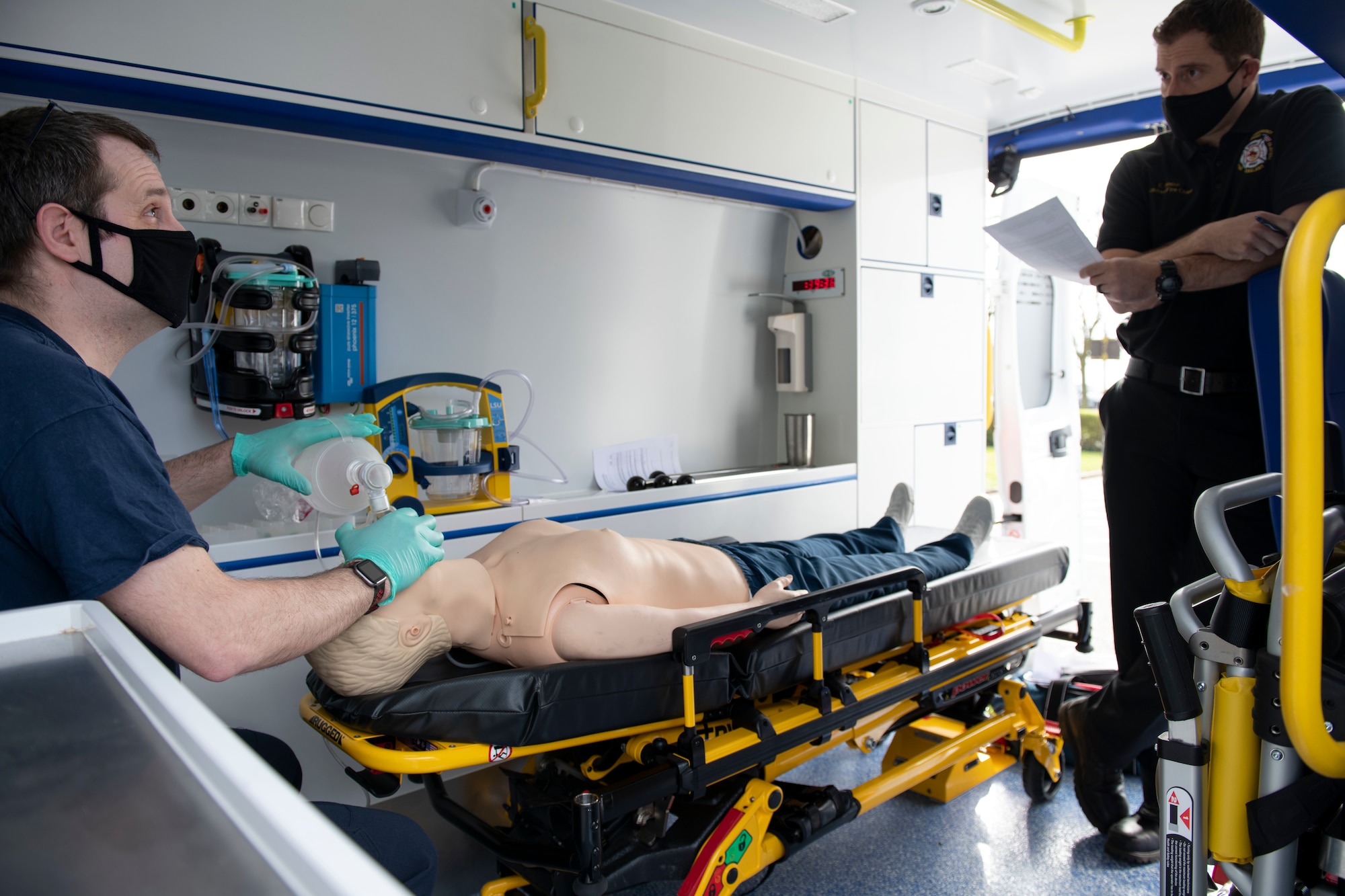 Andrew Boughen, 423rd Civil Engineer Squadron firefighter, assists a simulated patient with ventilation during an EMT practical application exam at Royal Air Force Croughton, England, March 31, 2021. U.K. firefighters across the 501st Combat Support Wing were tested in a practical application of their knowledge and skills, after attending over 280 hours of the U.S. National Registry of Emergency Medical Technicians course. The primary mission of the course was to prepare the fire department to respond to medical emergencies, as EMTs assume the responsibility of operating the ambulances and transporting patients to medical facilities. (U.S. Air Force photo by Senior Airman Jennifer Zima)