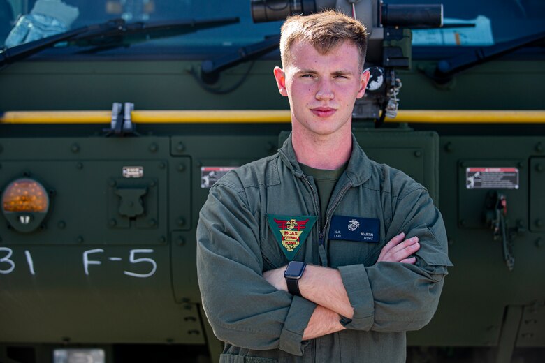 U.S. Marine Corps Lance Cpl. Nicklas Martin, an expeditionary firefighting and rescue (EFR) specialist with Headquarters and Headquarters Squadron (H&HS), Marine Corps Installations Pacific, poses for an environmental portrait on Marine Corps Air Station Futenma, Okinawa, Japan, April 7, 2021.  EFR specialist Marines with H&HS provide aircraft rescue and firefighting services in support of airfield operations and respond to any fire-related emergencies and situations with a maximum response time of five minutes. Martin is a native of Troy, Michigan. (U.S. Marine Corps photo by Lance Cpl. Alex Fairchild)