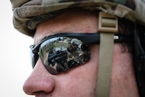 A U.S. Army Reserve Soldier watches Spc. Daniel P. Bush, Jr., a civil affairs specialist with the 418th Civil Affairs Battalion, fire a Mk 19 automatic grenade launcher during day one of the 2021 U.S. Army Civil Affairs and Psychological Operations Command (Airborne) Best Warrior Competition at Fort Jackson, S.C., April 8, 2021. The USACAPOC(A) BWC is an annual event that brings in competitors from across USACAPOC(A) to earn the title of “Best Warrior.” BWC tests the Soldiers’ individual ability to adapt and overcome challenging scenarios and battle-focused events, testing their technical and tactical skills under stress and extreme fatigue.