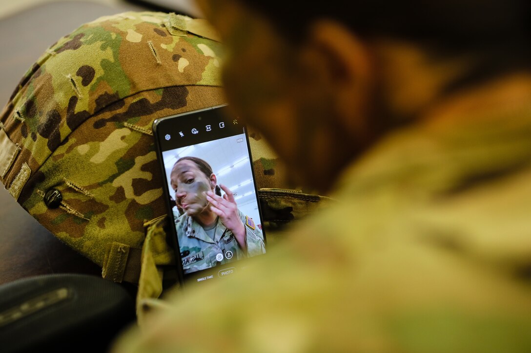 U.S. Army Reserve Spc. Arianna Hammel, an intelligence analyst with the 15th Psychological Operations Battalion, applies camouflage paint to prepare for a range qualification during day one of the 2021 U.S. Army Civil Affairs and Psychological Operations Command (Airborne) Best Warrior Competition at Fort Jackson, S.C., April 8, 2021. The USACAPOC(A) BWC is an annual event that brings in competitors from across USACAPOC(A) to earn the title of “Best Warrior.” BWC tests the Soldiers’ individual ability to adapt and overcome challenging scenarios and battle-focused events, testing their technical and tactical skills under stress and extreme fatigue.