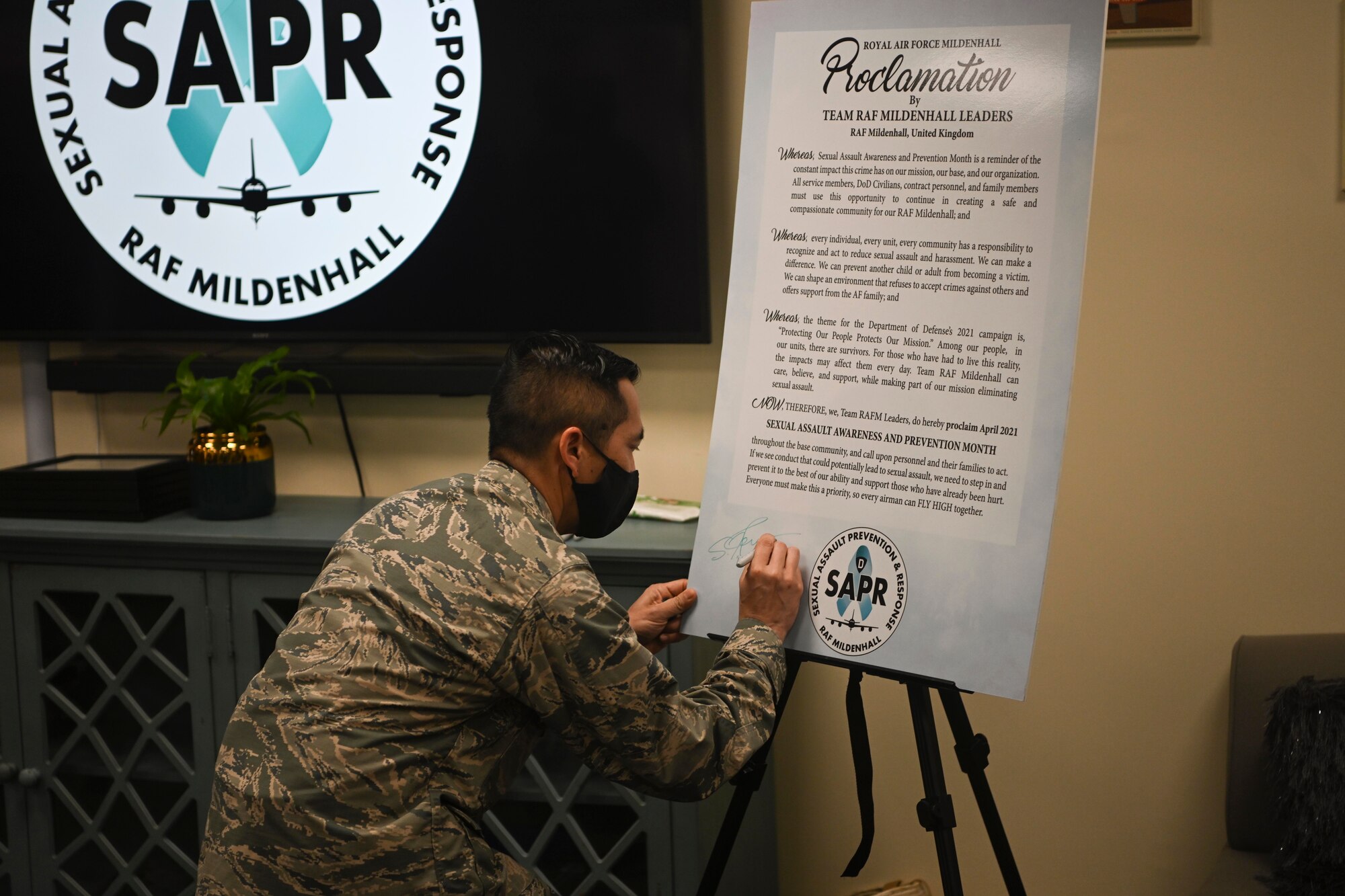 U.S. Air Force Col. Troy Pananon, 100th Air Refueling Wing commander, signs a proclamation designating April as Sexual Assault Awareness and Prevention Month at Royal Air Force Mildenhall, England, March 31, 2021. Protecting Airmen against sexual assault contributes to a ready force capable of executing the mission. (U.S. Air Force photo by Senior Airman Joseph Barron)