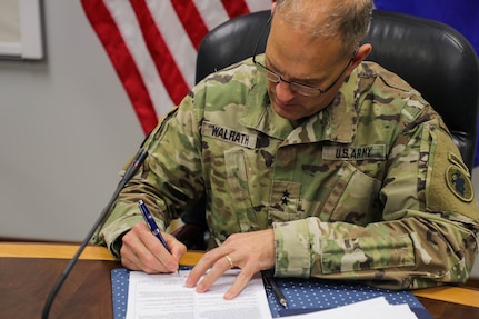 Maj. Gen. Daniel R. Walrath, Army South commanding general, signs the agreed-to-actions document between the U. S. and Salvadoran armies April 7, outlining future training commitments and professional exchanges between the two armies. (Photo by PFC Joshua Taeckens)