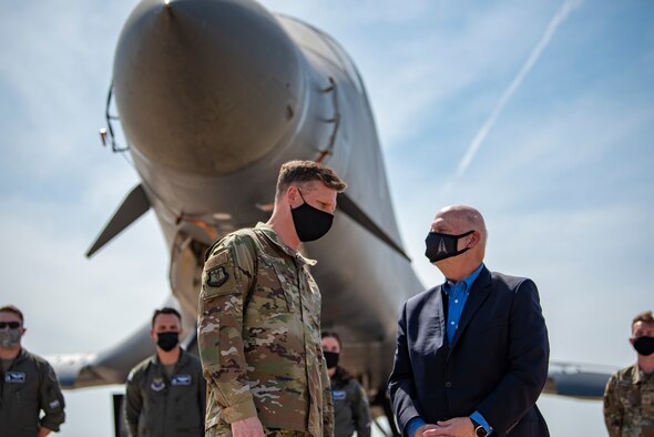Col. James Young, 317th Airlift Wing commander, talks with Acting Secretary of the Air Force John Roth on the flightline at Dyess Air Force Base, Texas, April 6, 2020. During the visit, Dyess Airmen highlighted the B-1’s global strike ability while showcasing the 317th AW and how they are leading the way for tactical airlift capabilities. (U.S. Air Force photo by Airman 1st Class Colin Hollowell)