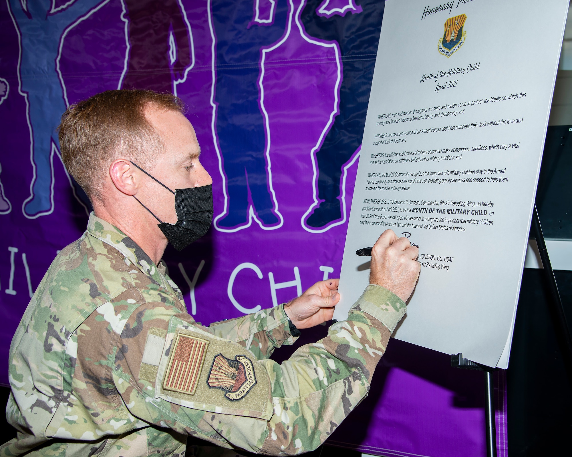 U.S. Air Force Col. Benjamin Jonsson, 6th Air Refueling Wing commander, signs a proclamation for Month of the Military Child at MacDill Air Force Base, Fla., April 5, 2021.