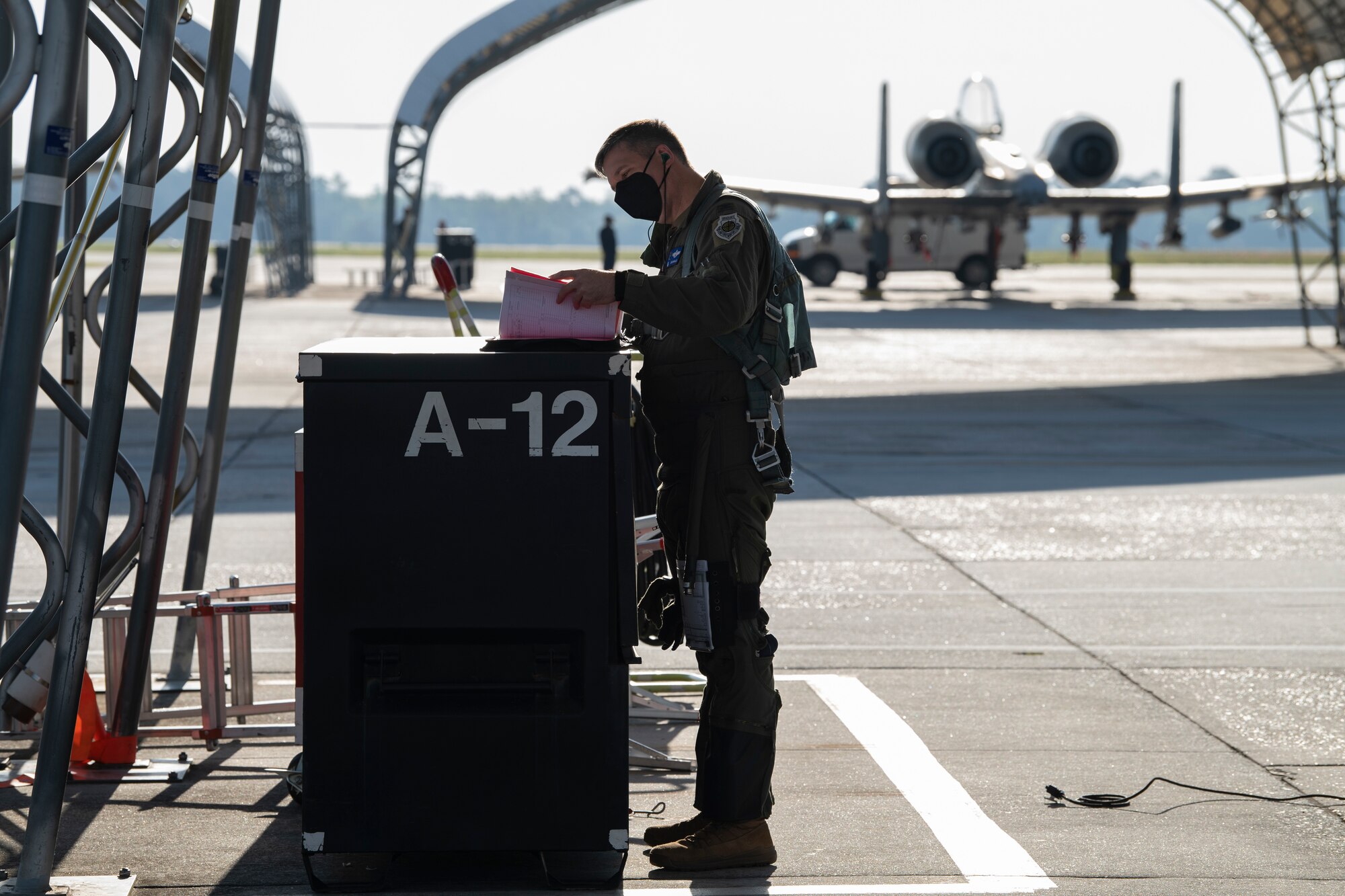 A photo of an Airman looking at a booklet.
