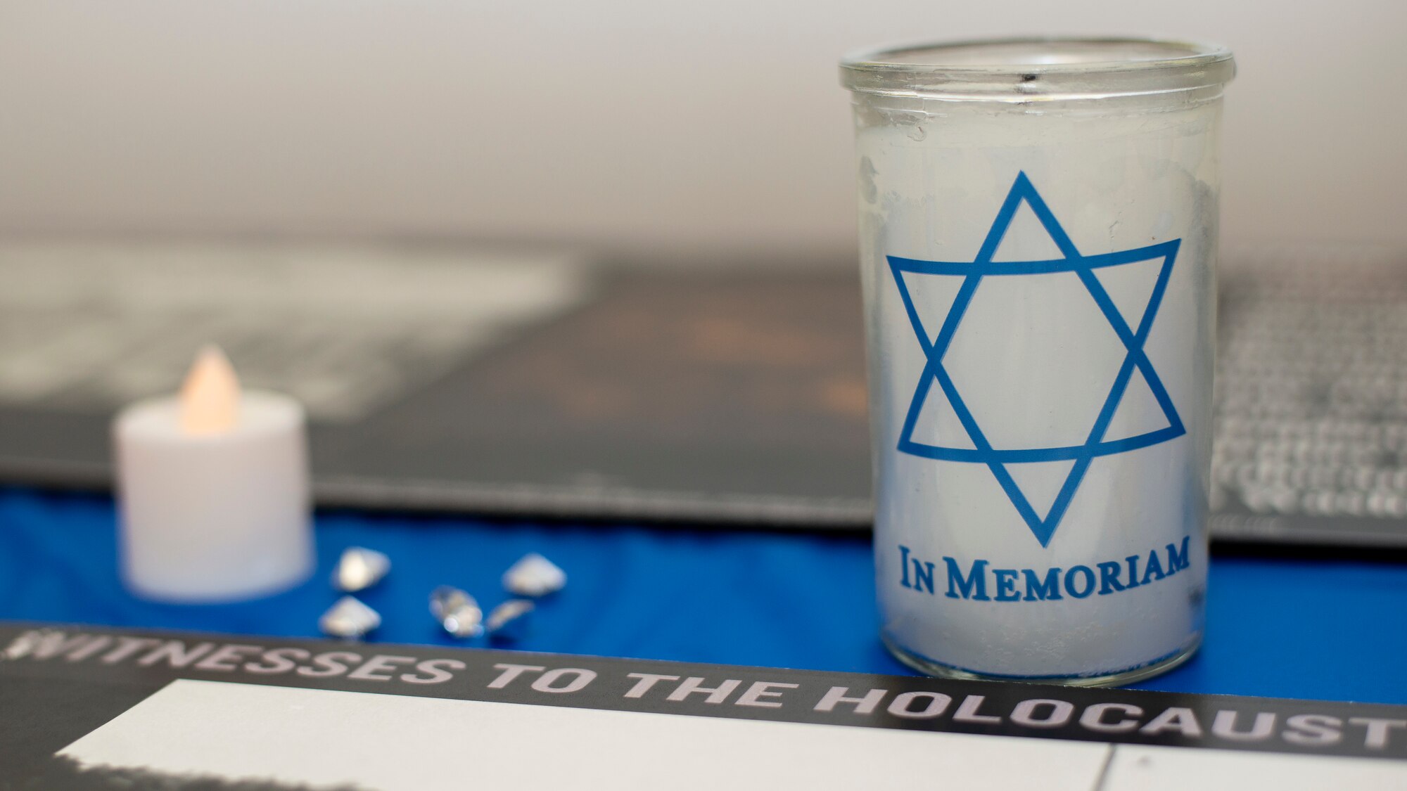 Memorial candles and gems are displayed at a Holocaust Memorial at MacDill Air Force Base, Fla., April 8, 2021.