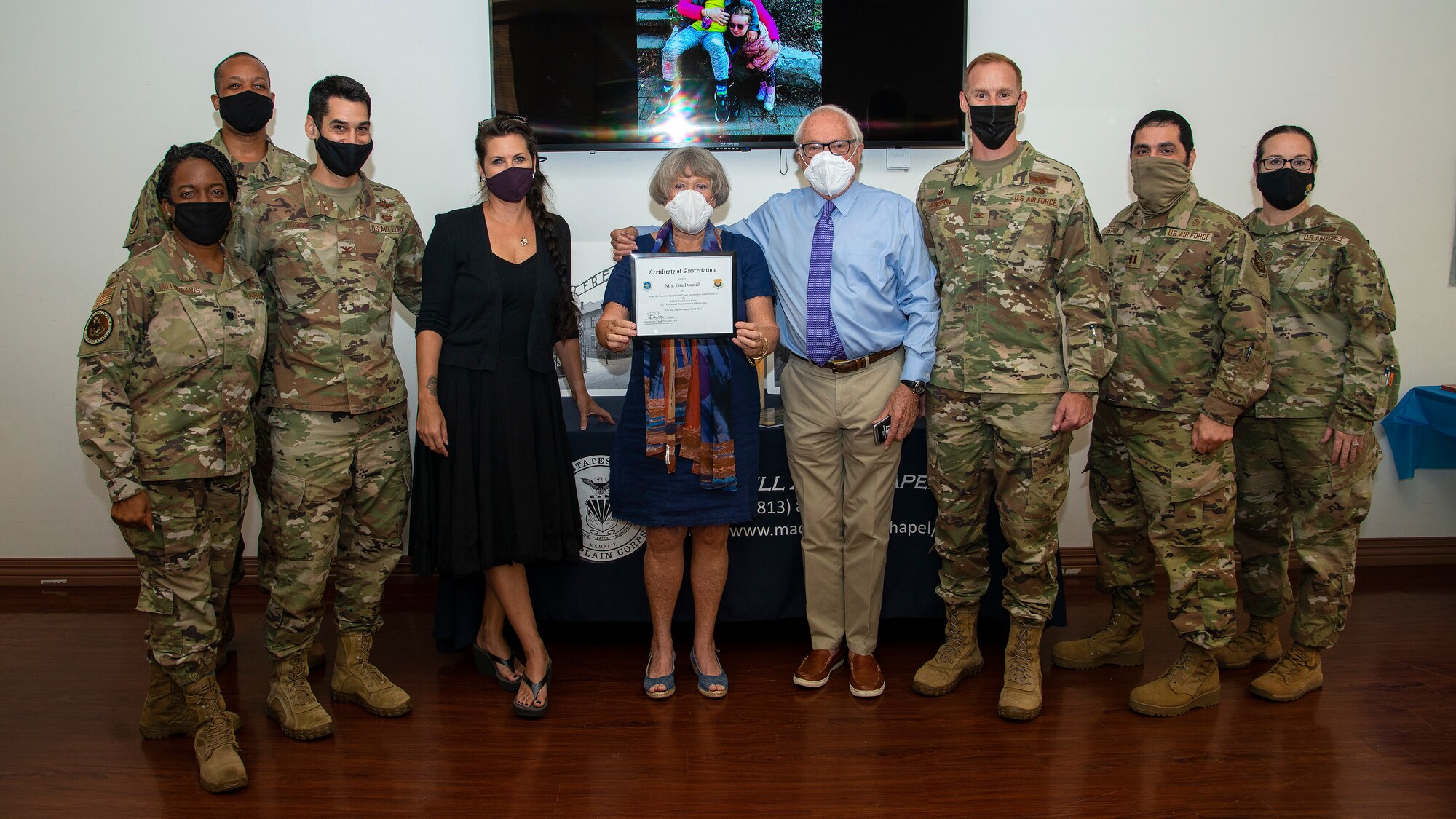 The 6th Air Refueling Wing (ARW) and MacDill Air Force Base, Fla., chapel leadership gather for a group photo with Mrs. Etta Donnell, Holocaust survivor, and her husband Stewart, at a Holocaust Memorial at MacDill, April 8, 2021.