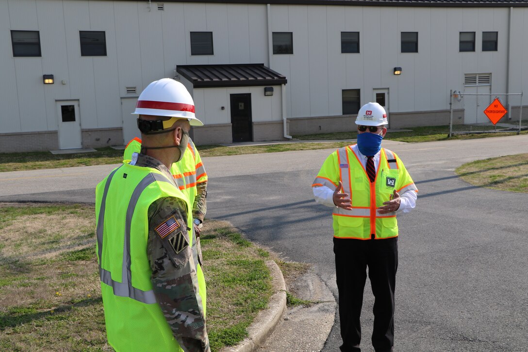 Team members discuss issues on a construction site at Dover Air Force Base, DE
