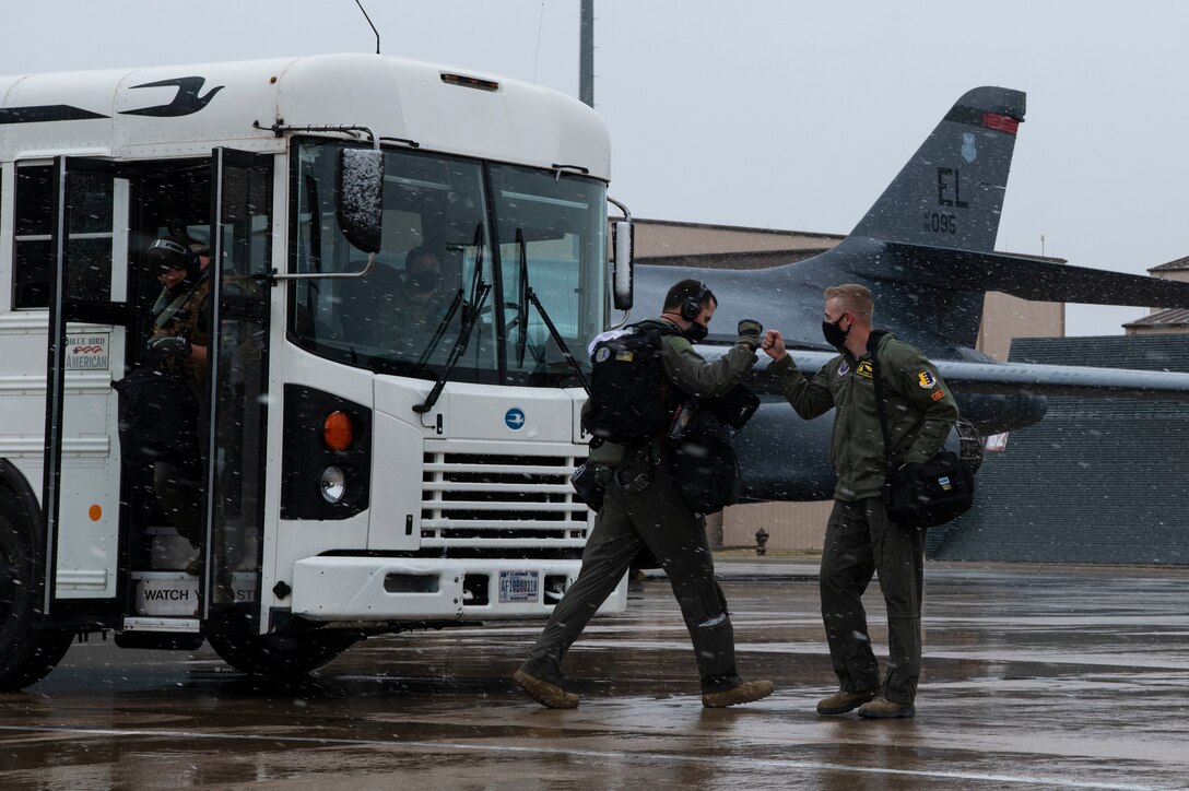Aviators from the 37th Bomb Squadron greet each other before the start of a Bomber Task Force mission at Ellsworth Air Force Base, S.D., April 6, 2021.